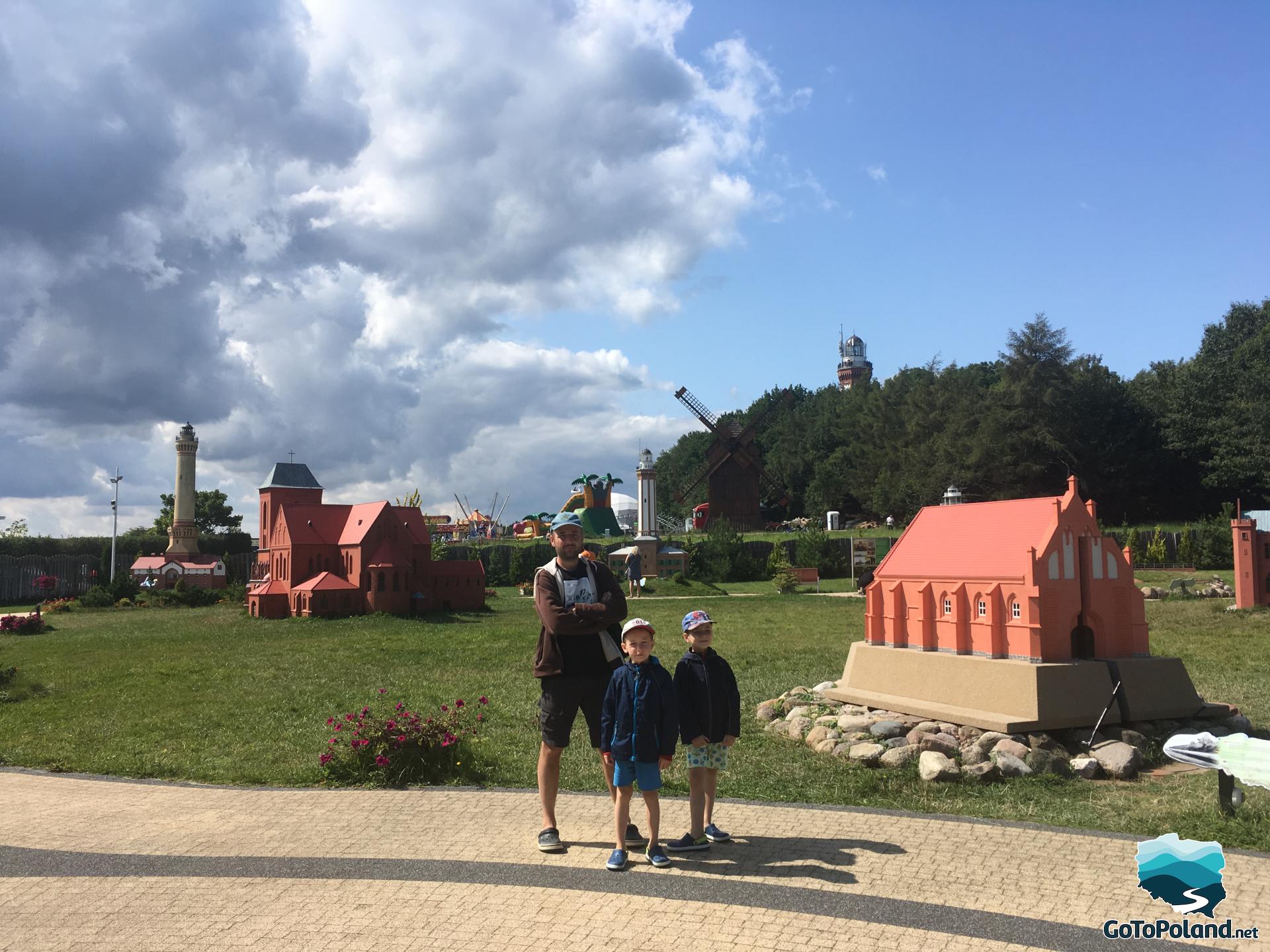 a man and two boys in the miniature park