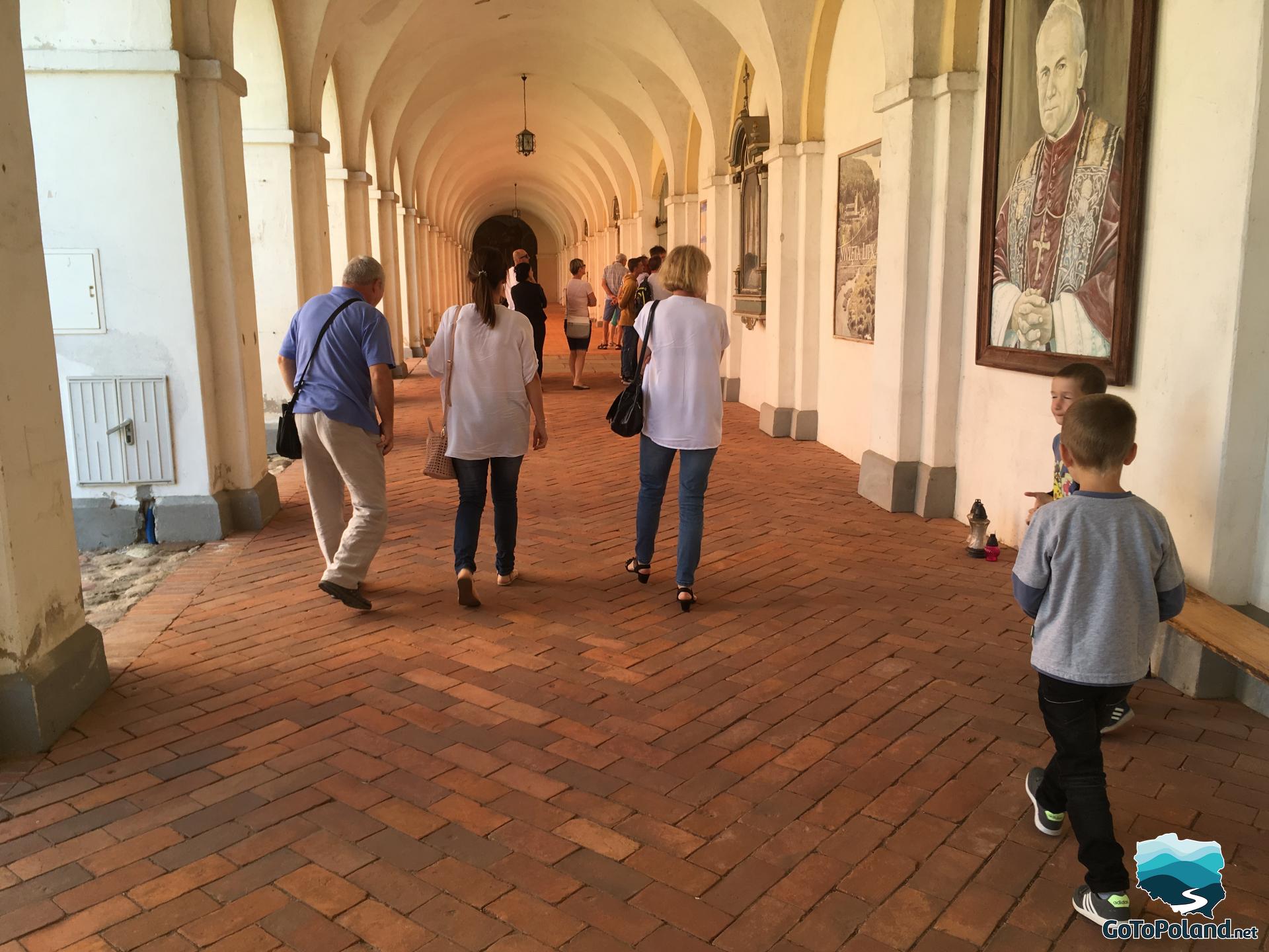 people walking in the cloisters