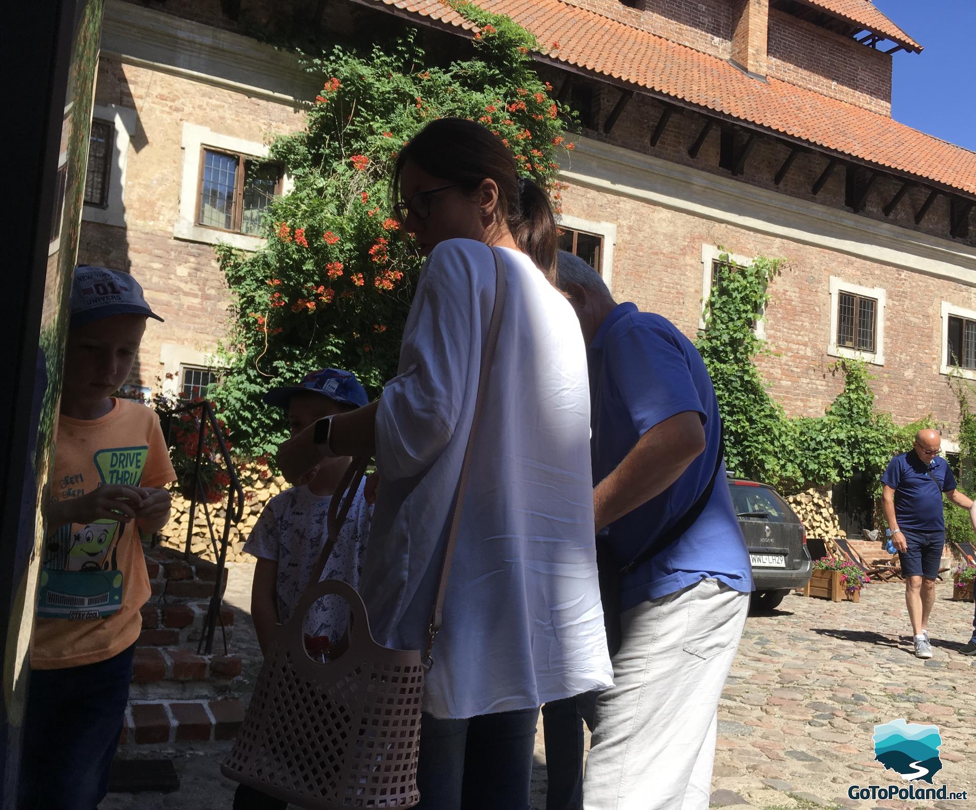 a family is in the courtyard of the castle