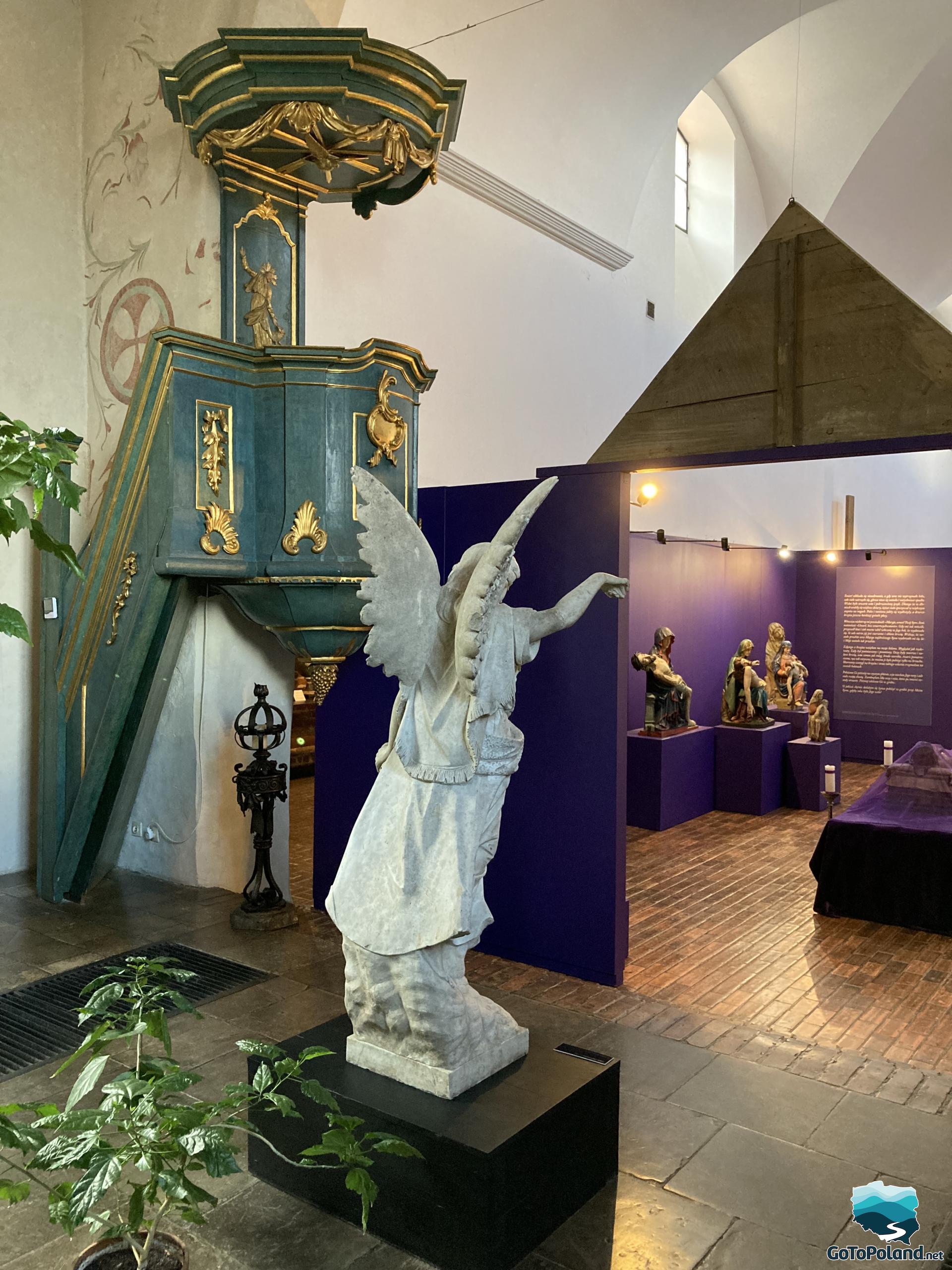 a pulpit and a sculpture of an angel