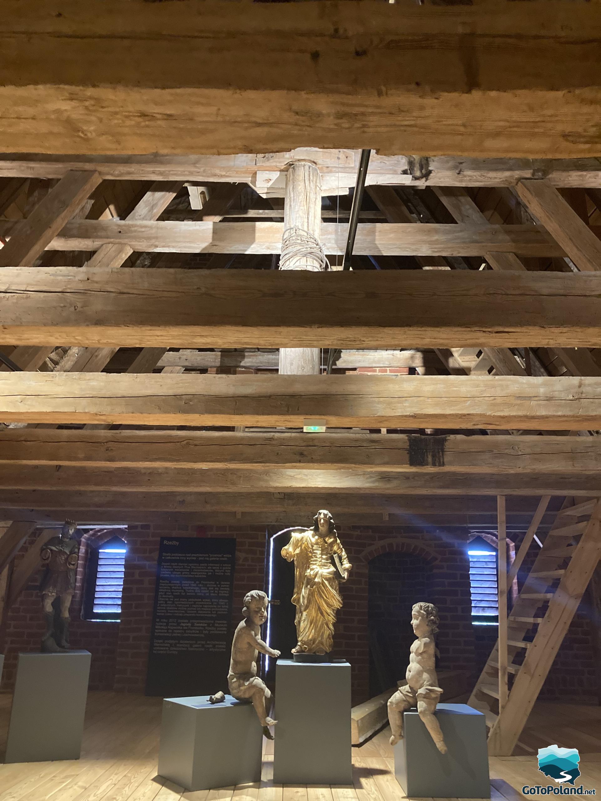 three sculptures of saints in the attic of the cathedral