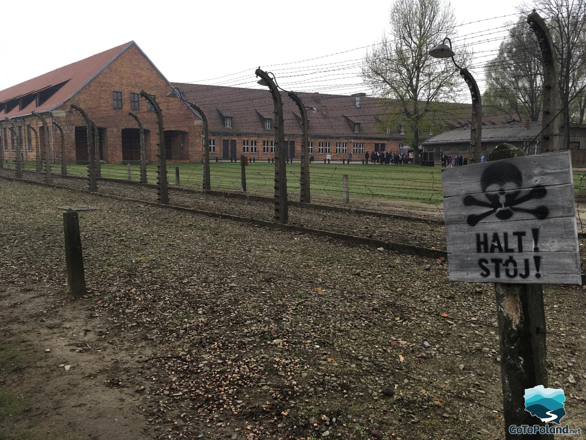 barracks on the site of the former nazi camp surrounded by barbed wire
