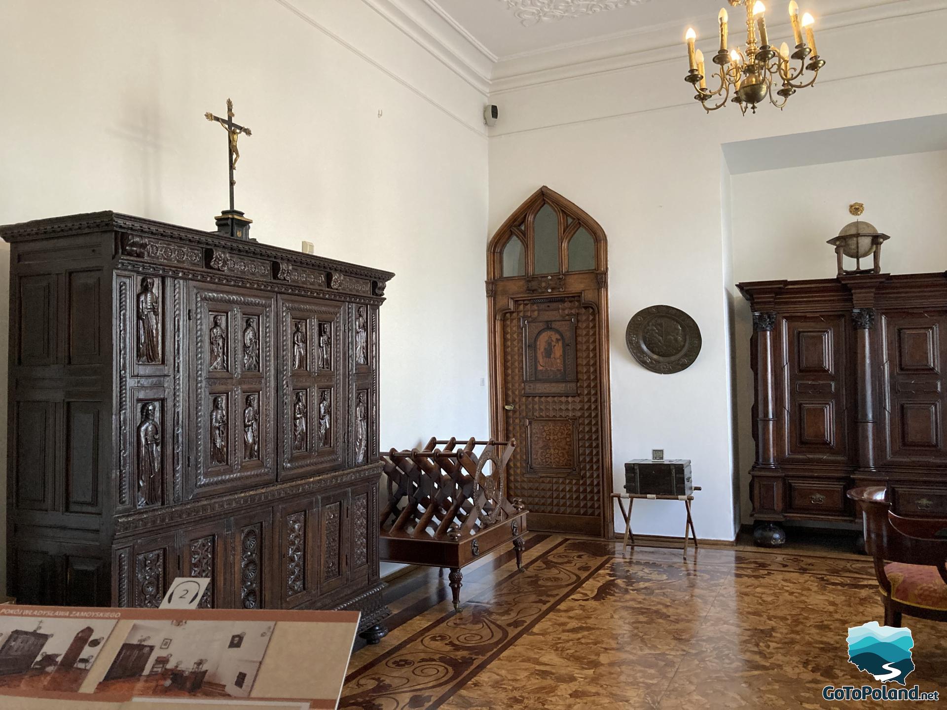 A room with wooden furniture, an oak wardrobe and an inlaid floor