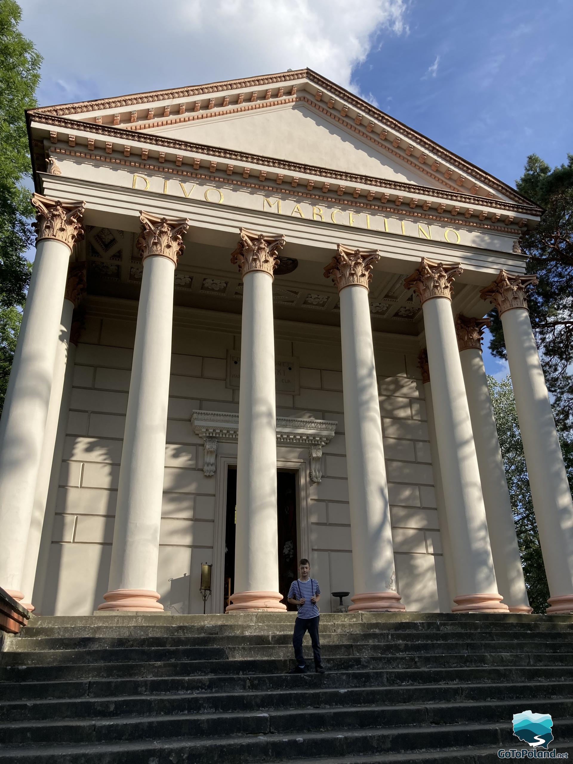 a boy is staring on stairs leading to the church