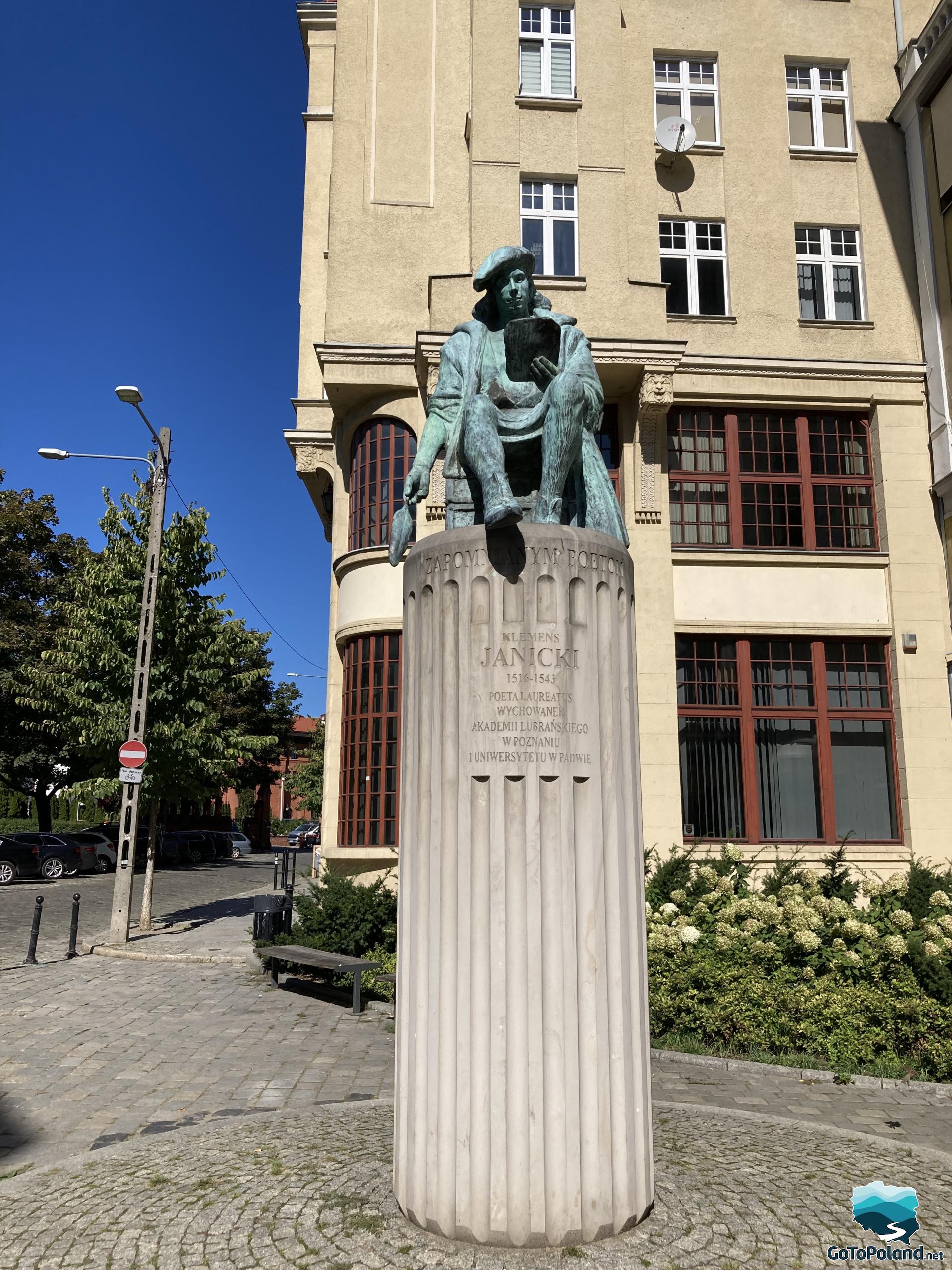 a sculpture of a man placed on a high column