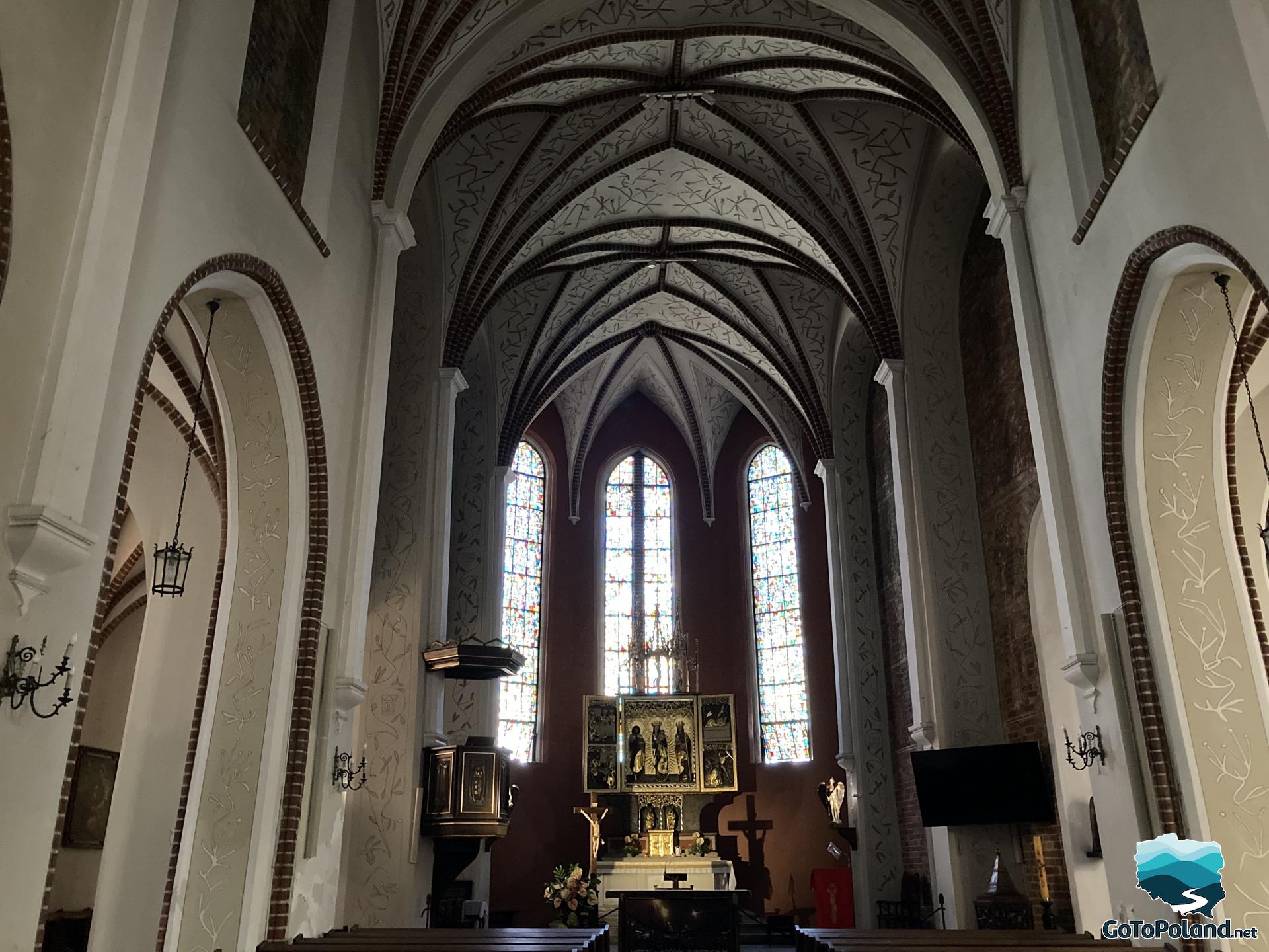 dark interior of a church with a high vault