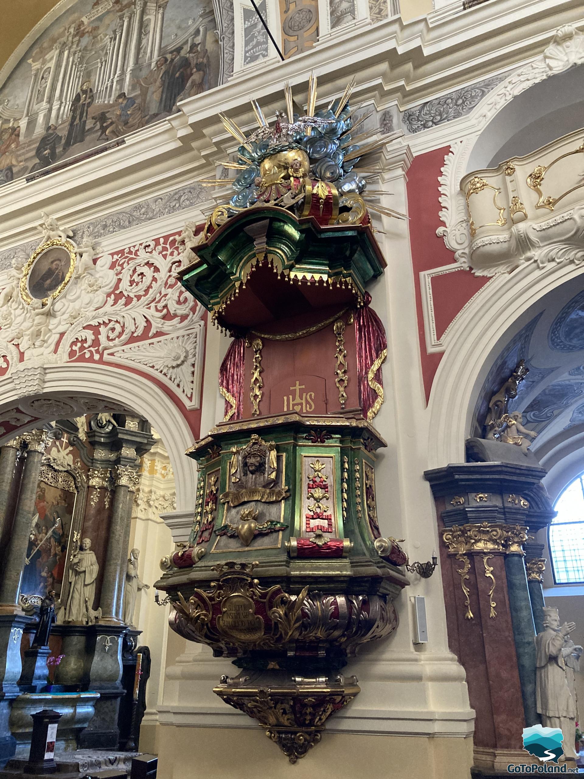 red and green pulpit with rich gilded ornaments