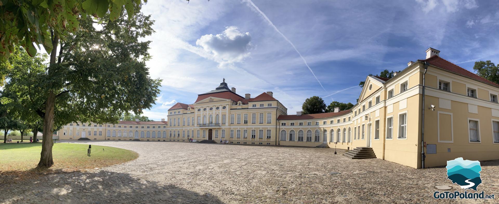 quite big palace with bright yellow facade and red roof