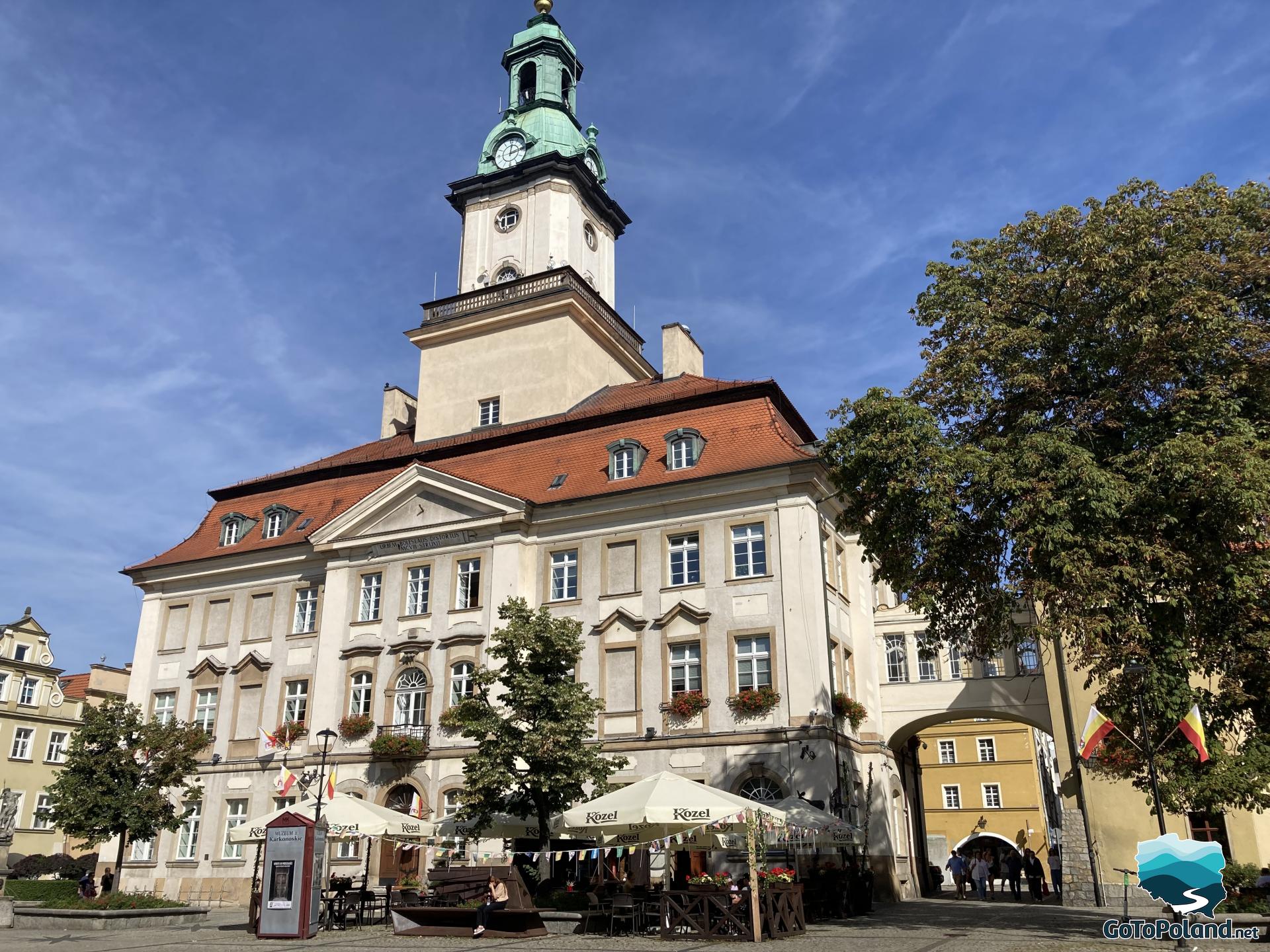 a building of a city hall with one tower and red roof