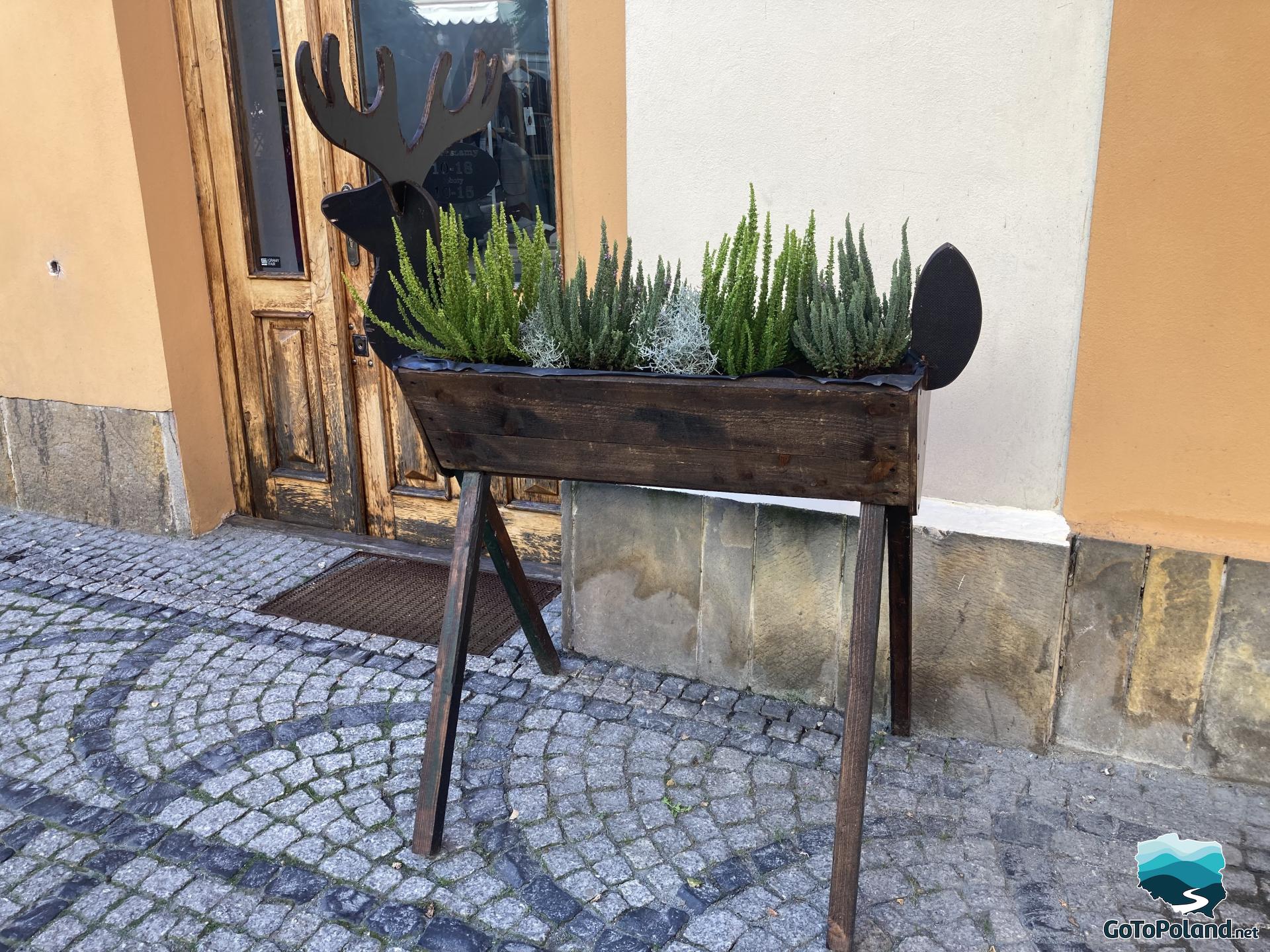 a flower box in the form of a deer with heather inside