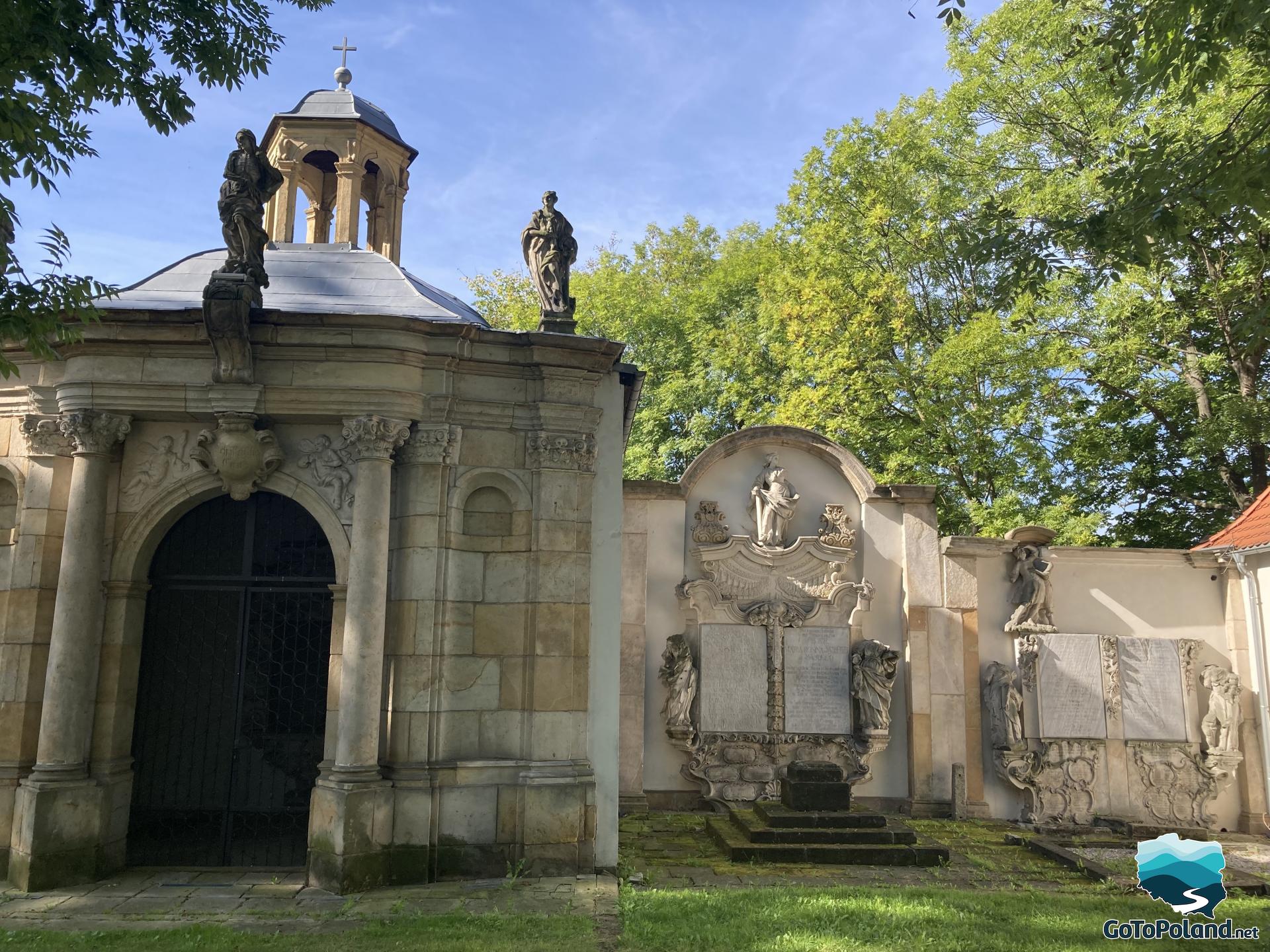 a stone grave chapel decorated with many sculptures 