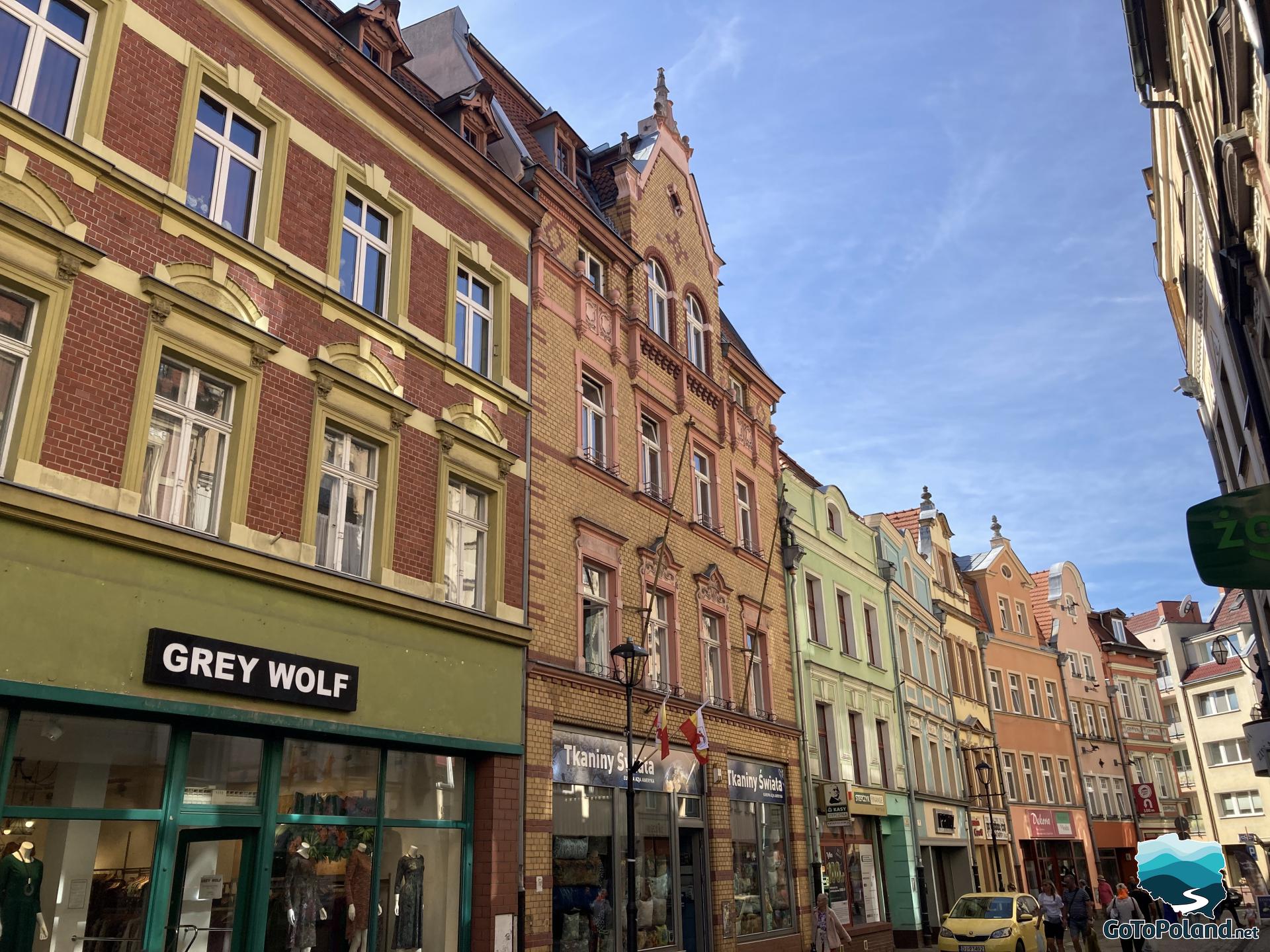 colorful tenement houses with shops on the ground floor and apartments on the first floor