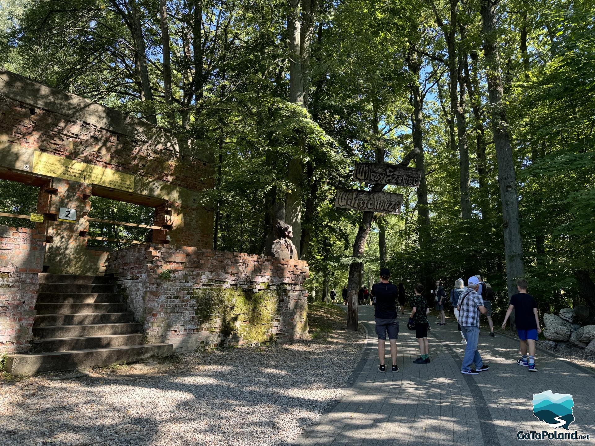 a group of tourists on a path leading next to the bunker