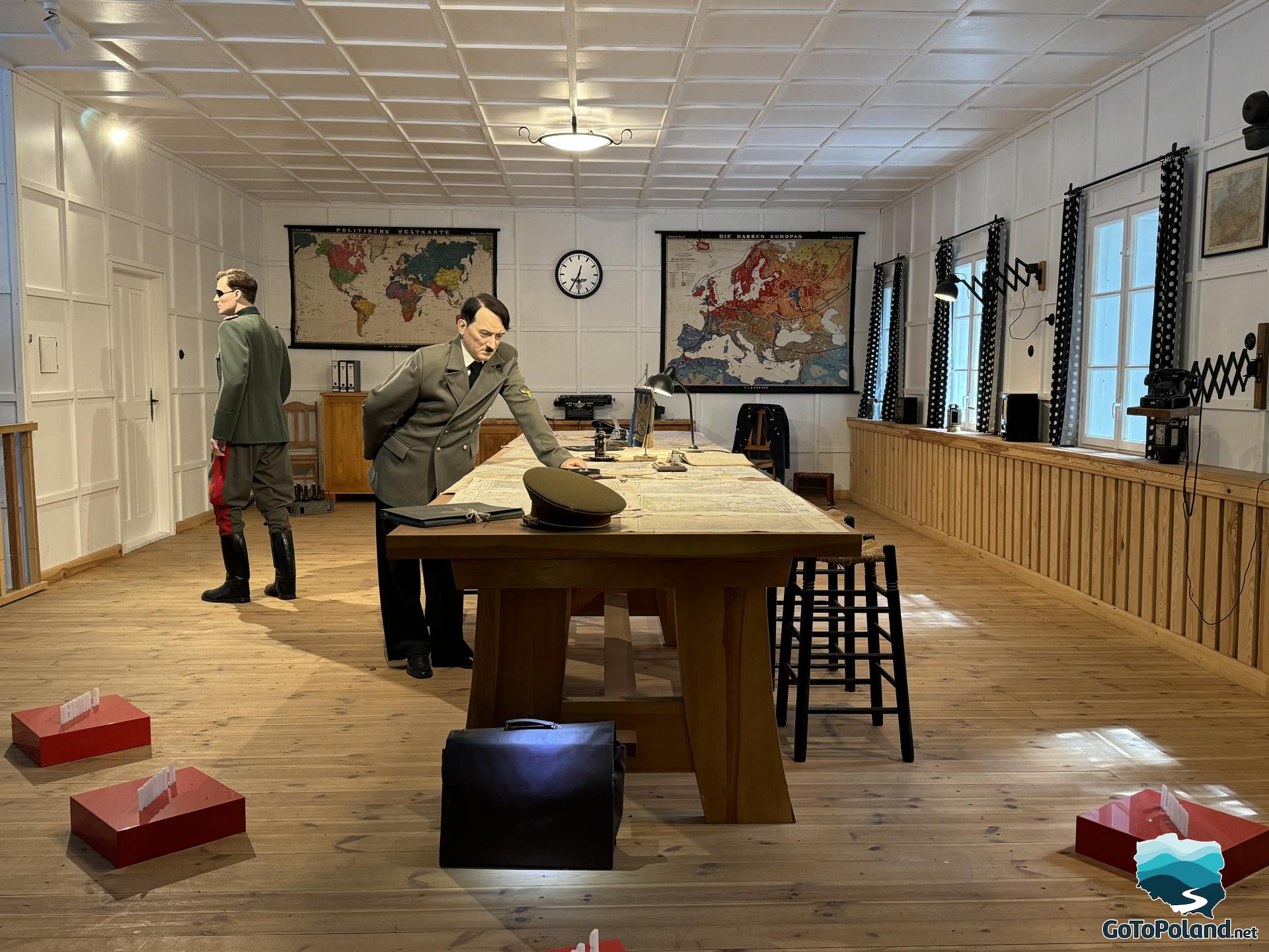 staging, Hitler leans over the conference table, a briefcase with a bomb stands on the floor next to it, an assassin leaves the room