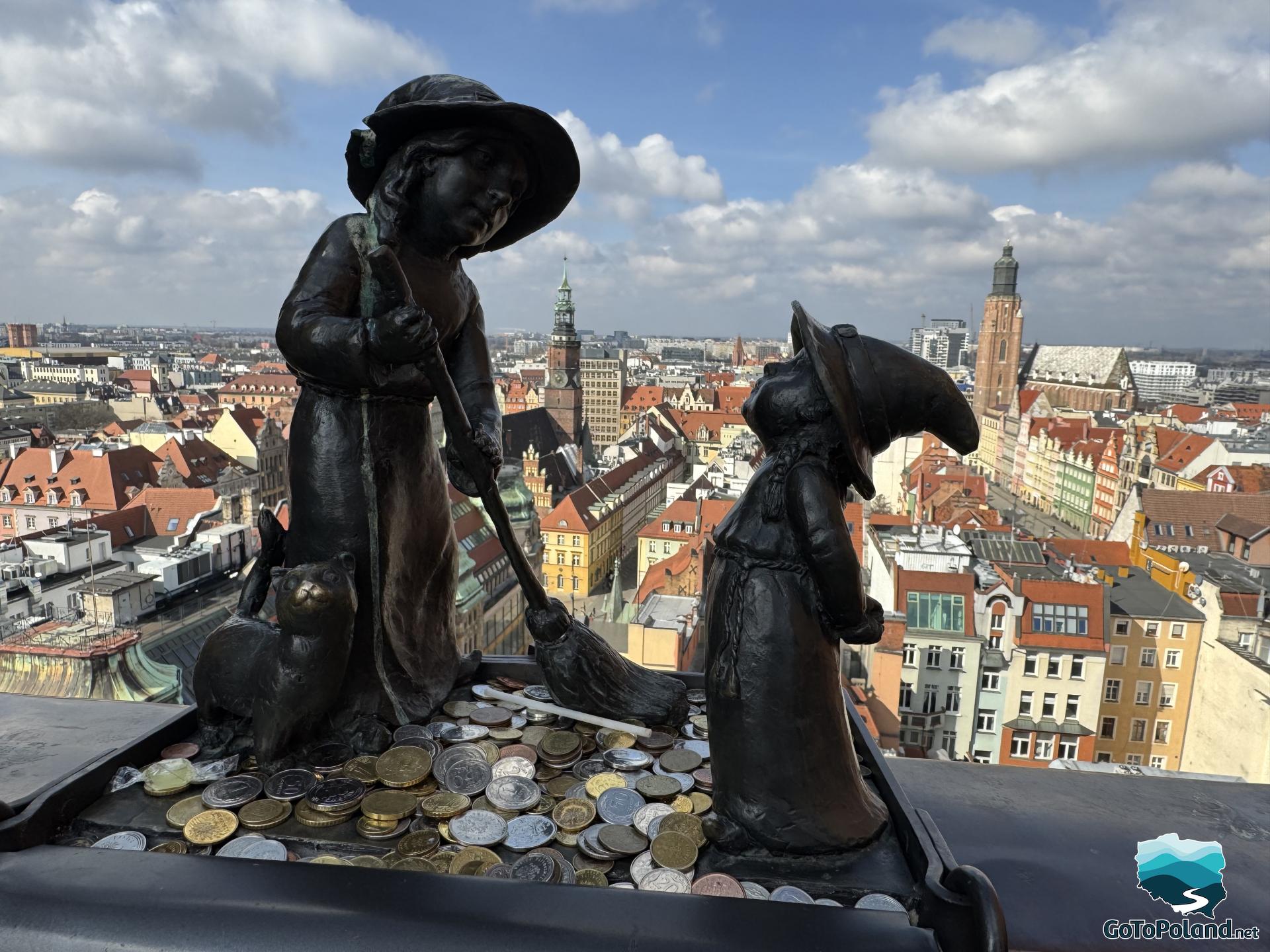 two little gnomes sitting on the railing of the viewpoint