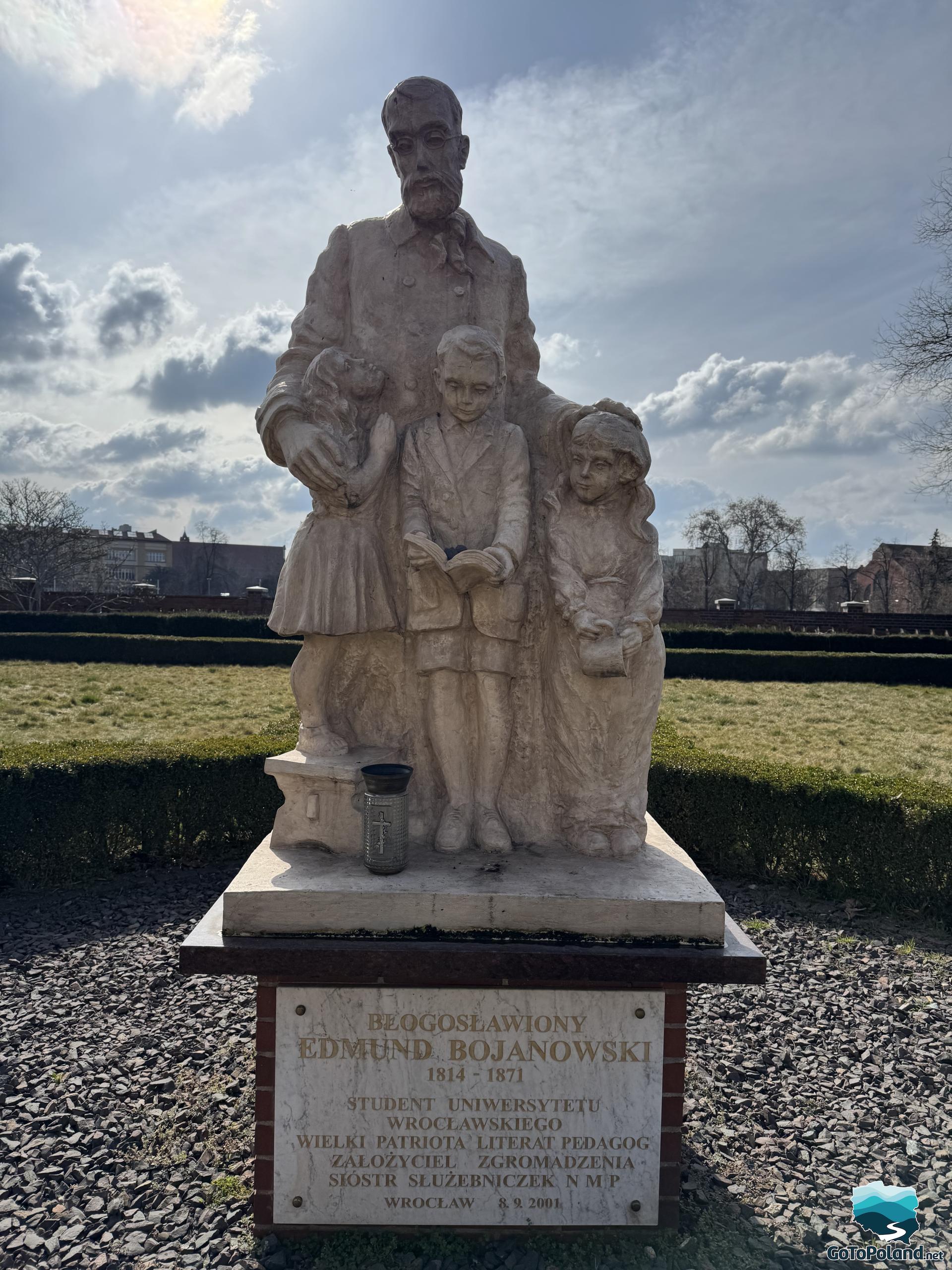 a stone monument to the founder of the Sister Servants Association, standing in the garden