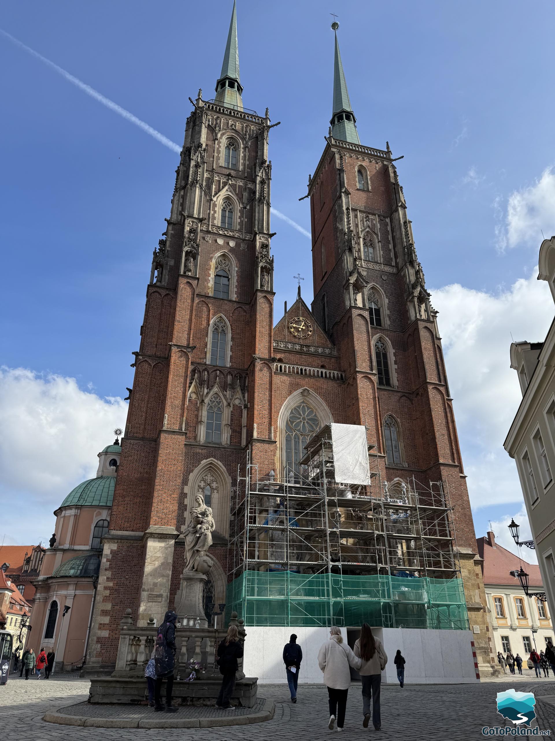 a church with tall towers seen from up close