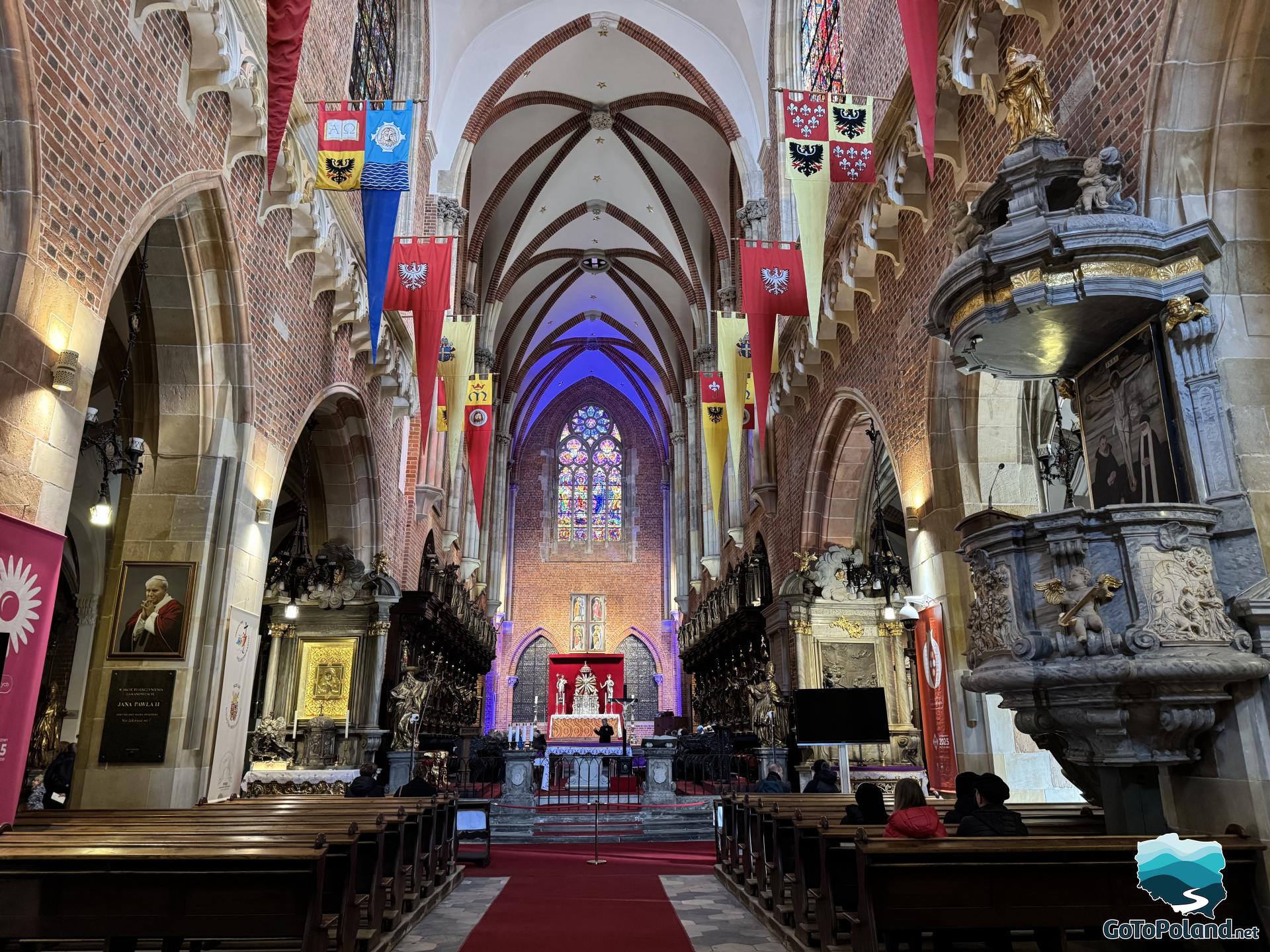 the interior of the church is illuminated by the colored light coming from the stained glass windows