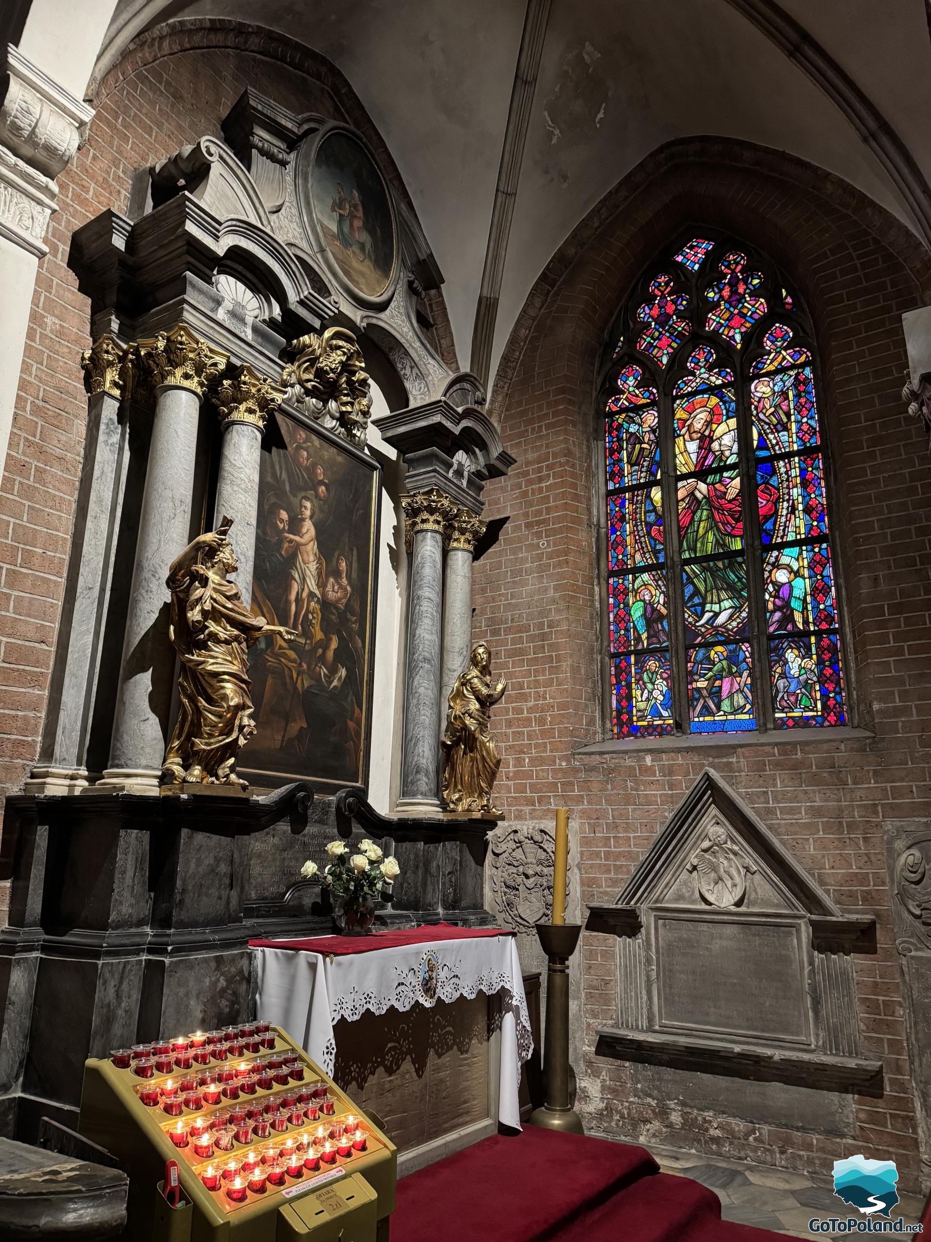 a small chapel with a small altar and stained glass window