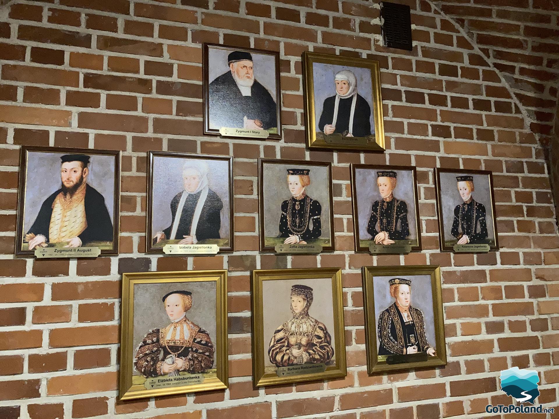 a wall in a castle with portraits of Polish rulers hanging on it
