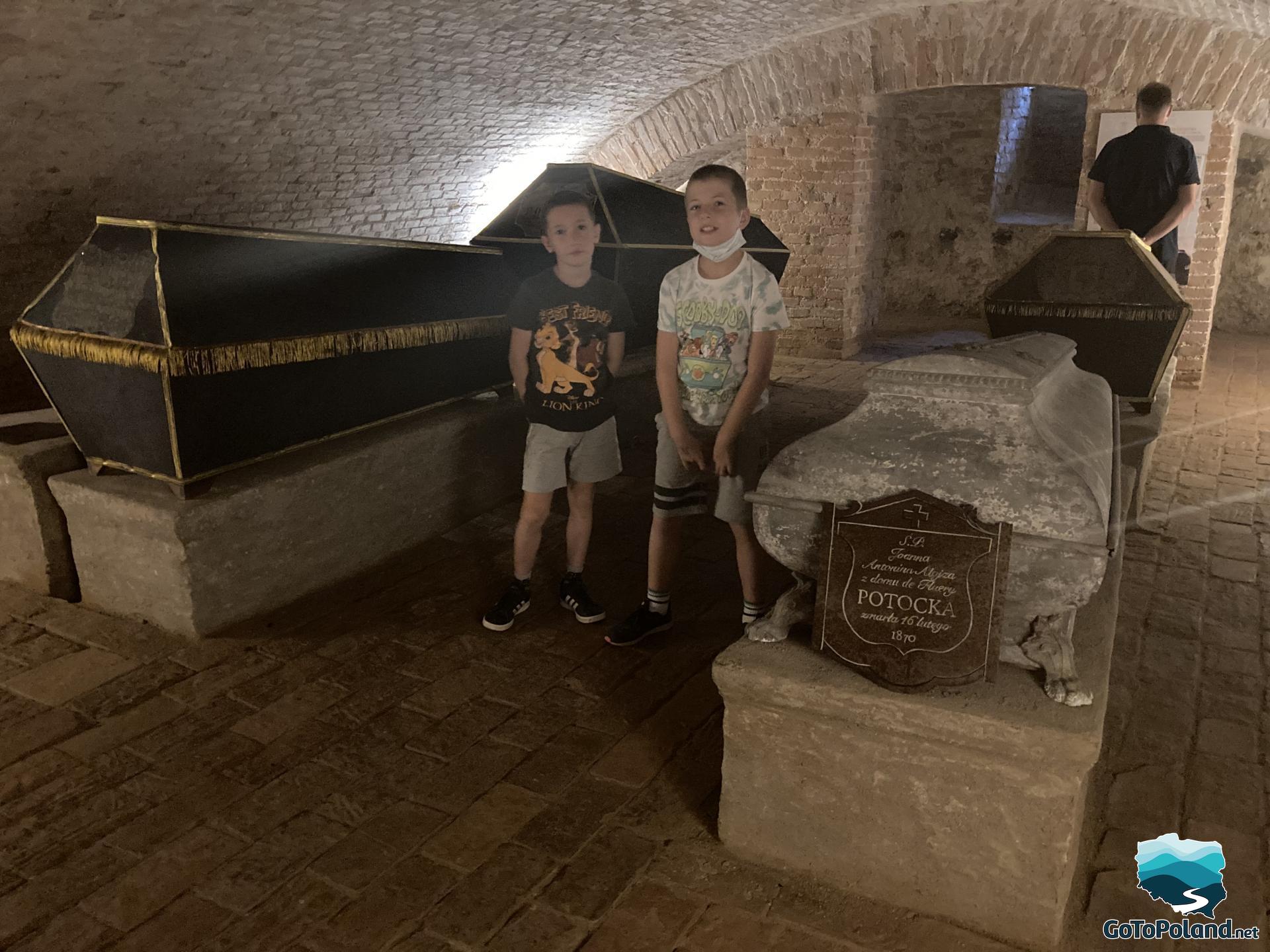 two children are in the crypt by the graves