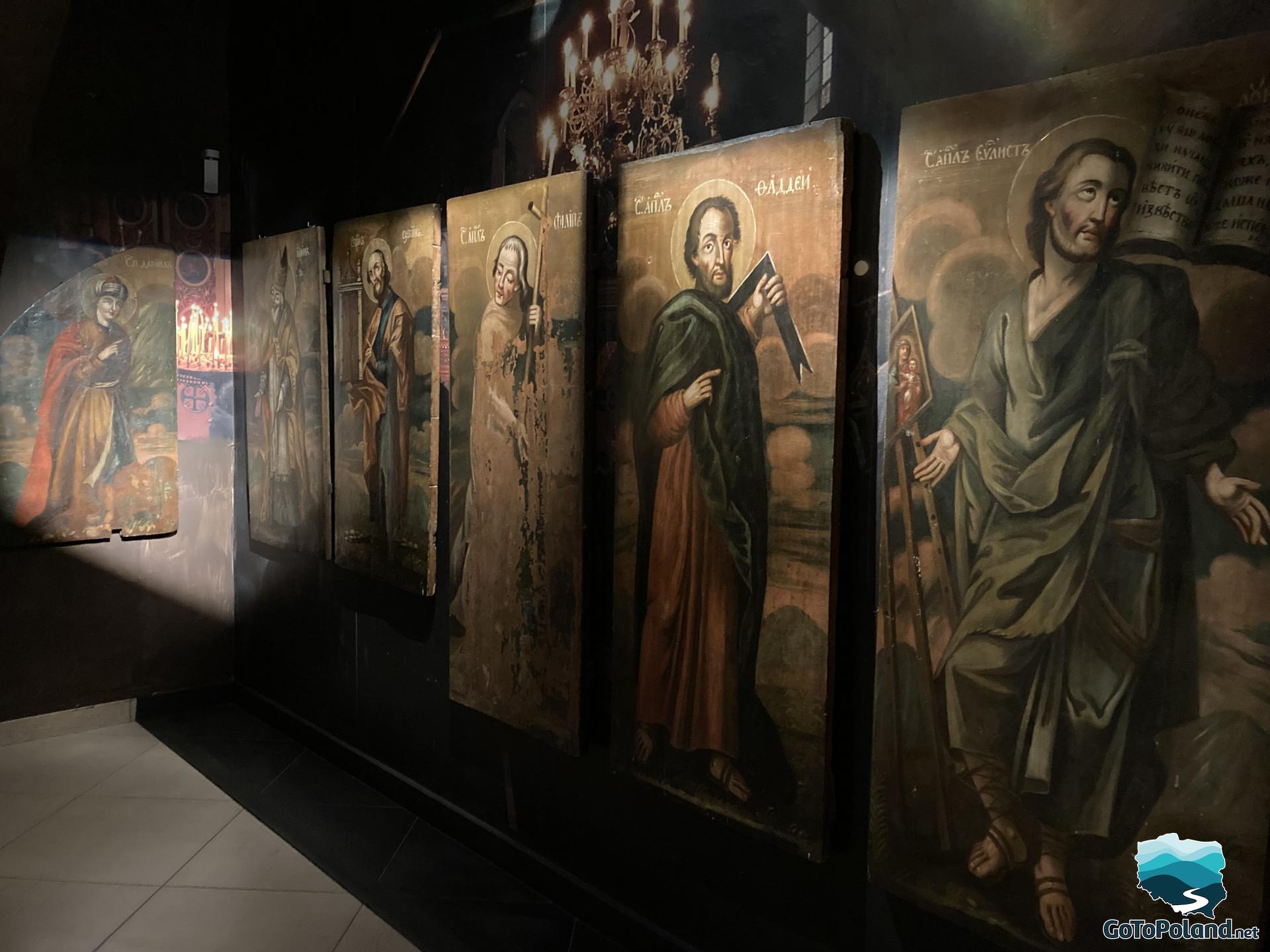 a wall with icons of saints