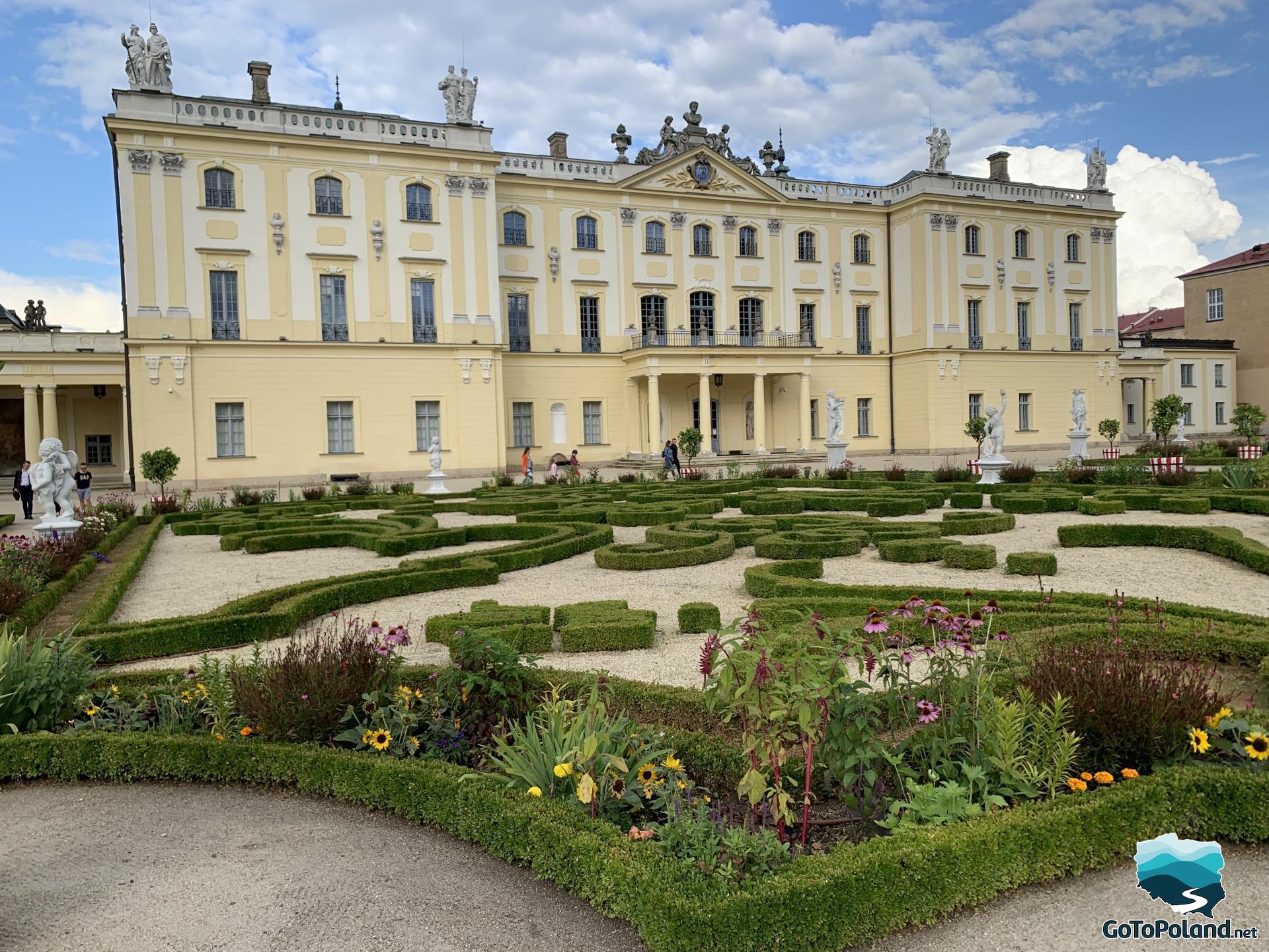 a palace garden in the foreground and the palace in the background 