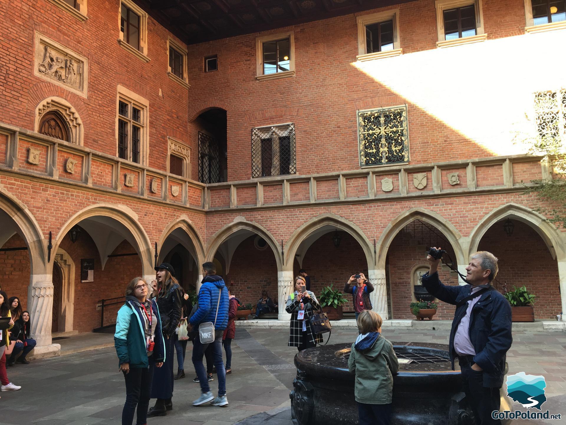 a group of young people in the courtyard of the Jagiellonian University