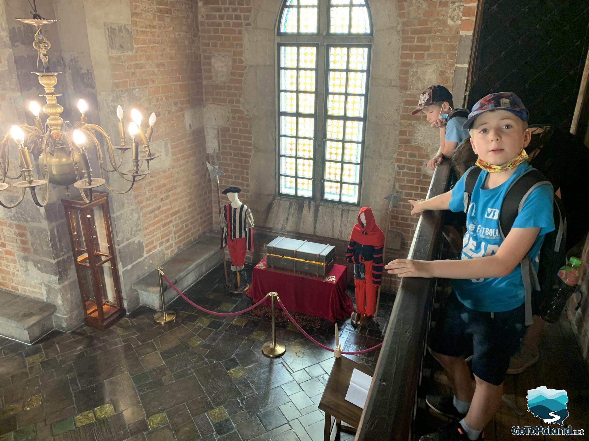 two boys watching exhibits in a tower (old clothes)