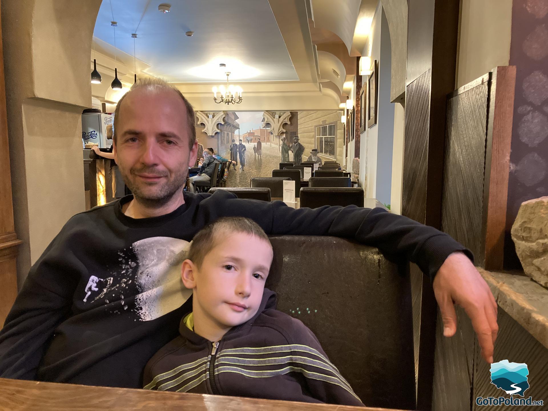 a man and a boy are sitting in a jewish restaurant