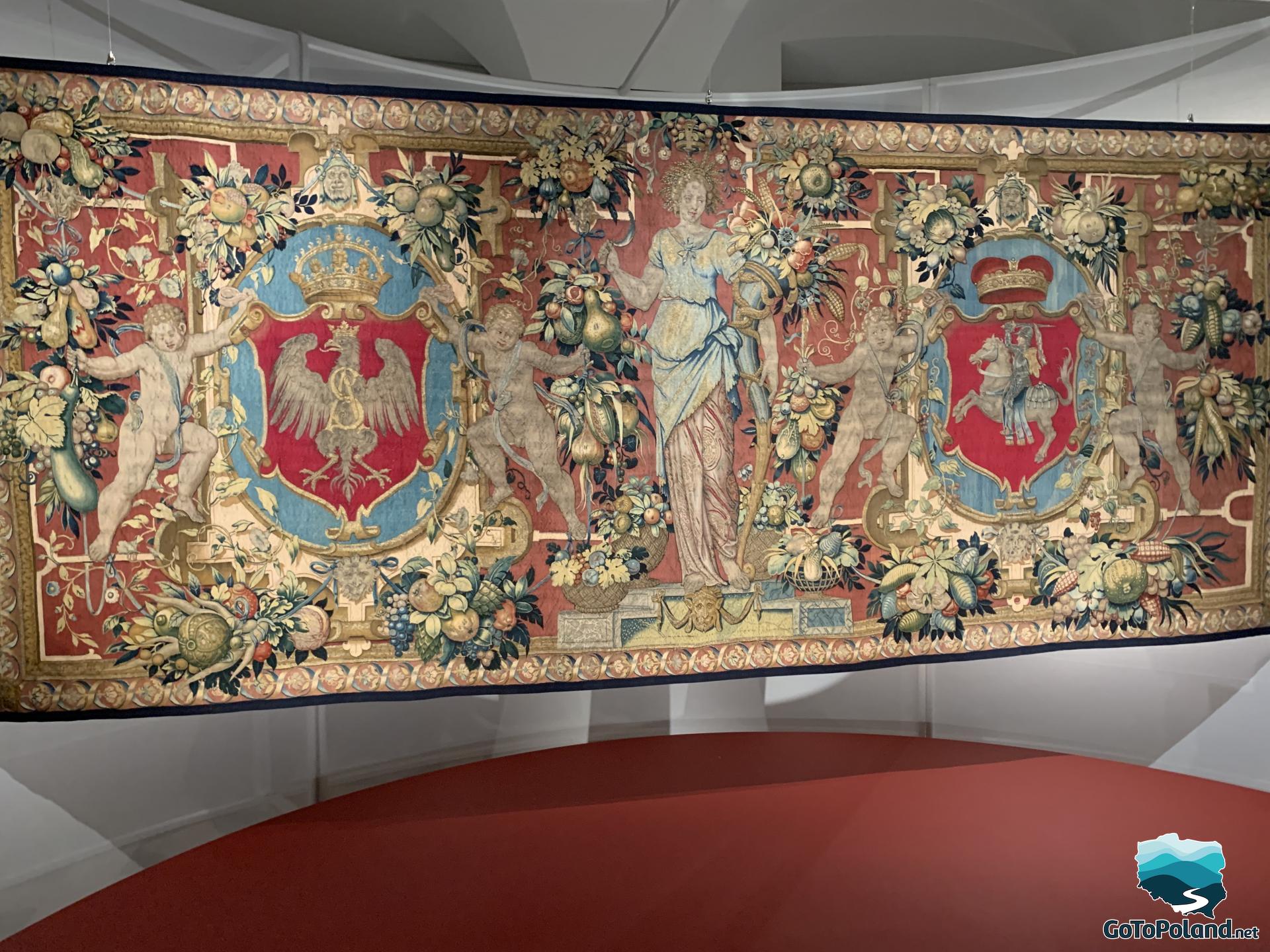 a tapestry belonging to King Zygmunt August, this tapestry is colored with fruits, flowers and four cupids