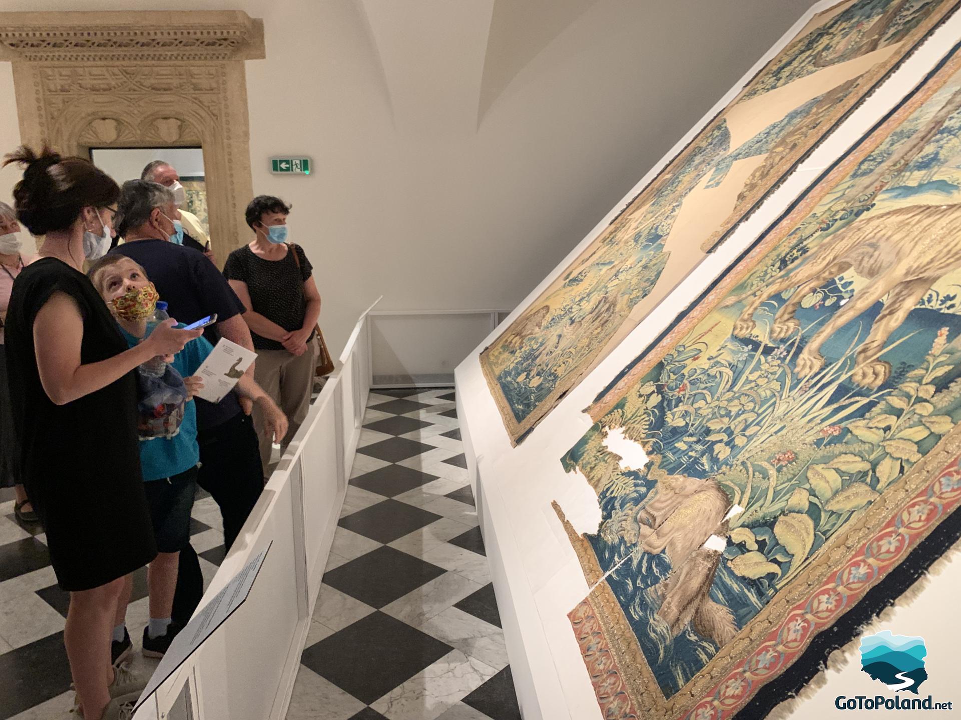visitors are watching tapestries 