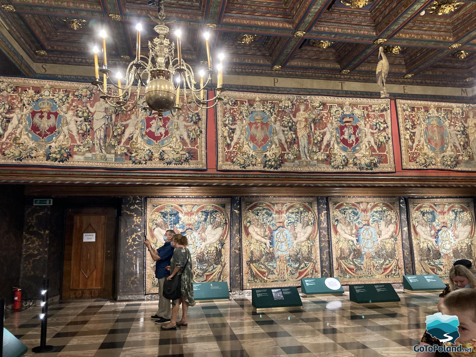 a big hall in a castle with tapestries