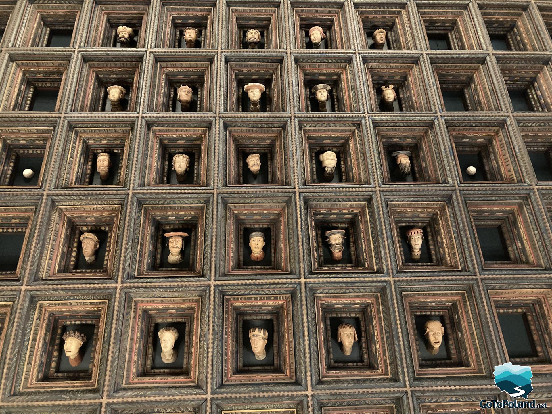 a ceiling in the castle with images of carved heads