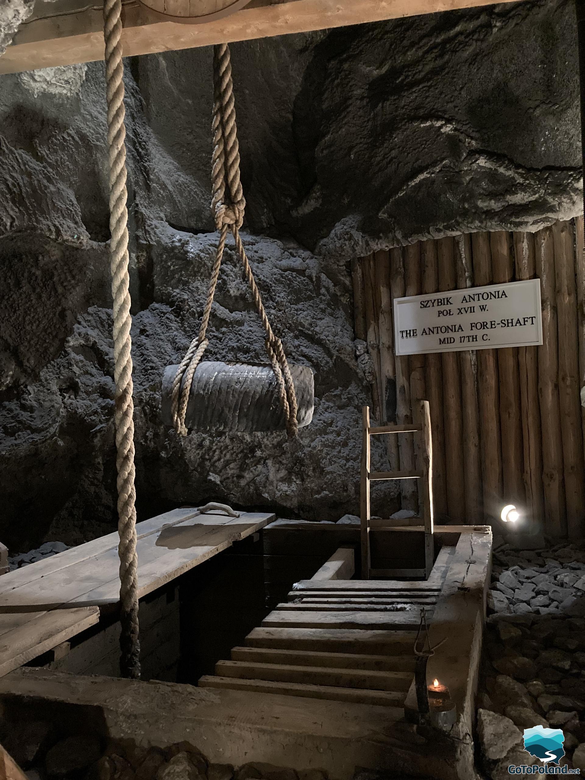 a mining shaft in a salt mine, some ropes and a ladder, walls of salt