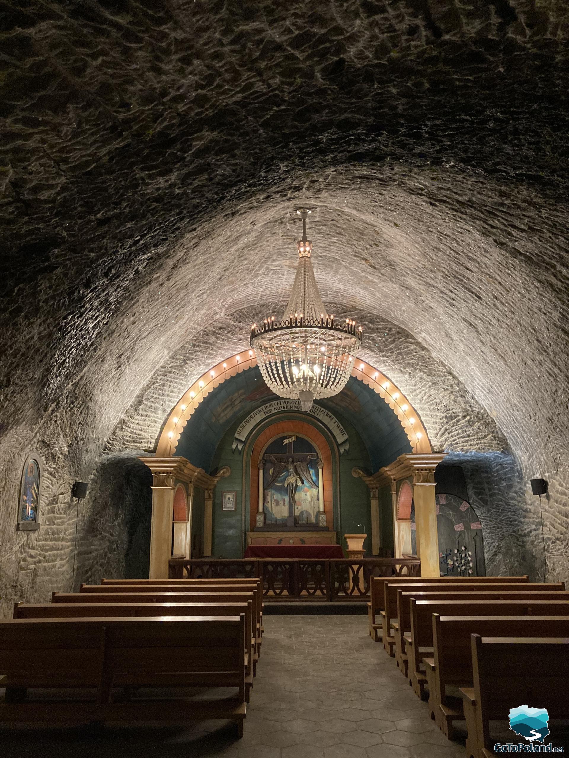 a small chamber carved in salt, served as a chapel, there are two rows of wooden pews, small altar and one chandelier