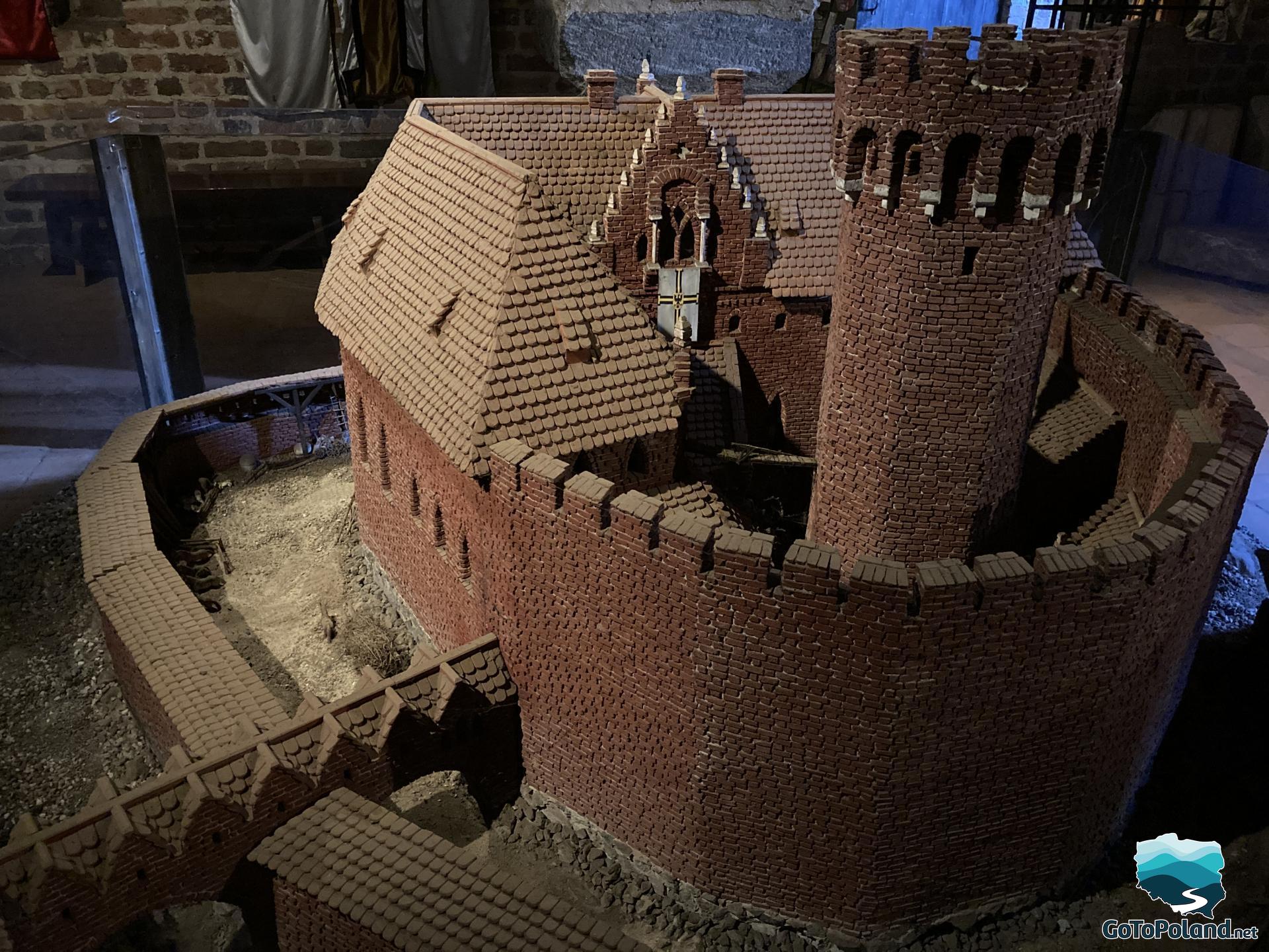 a red brick castle model surrounded by brick wall with the brick tower 