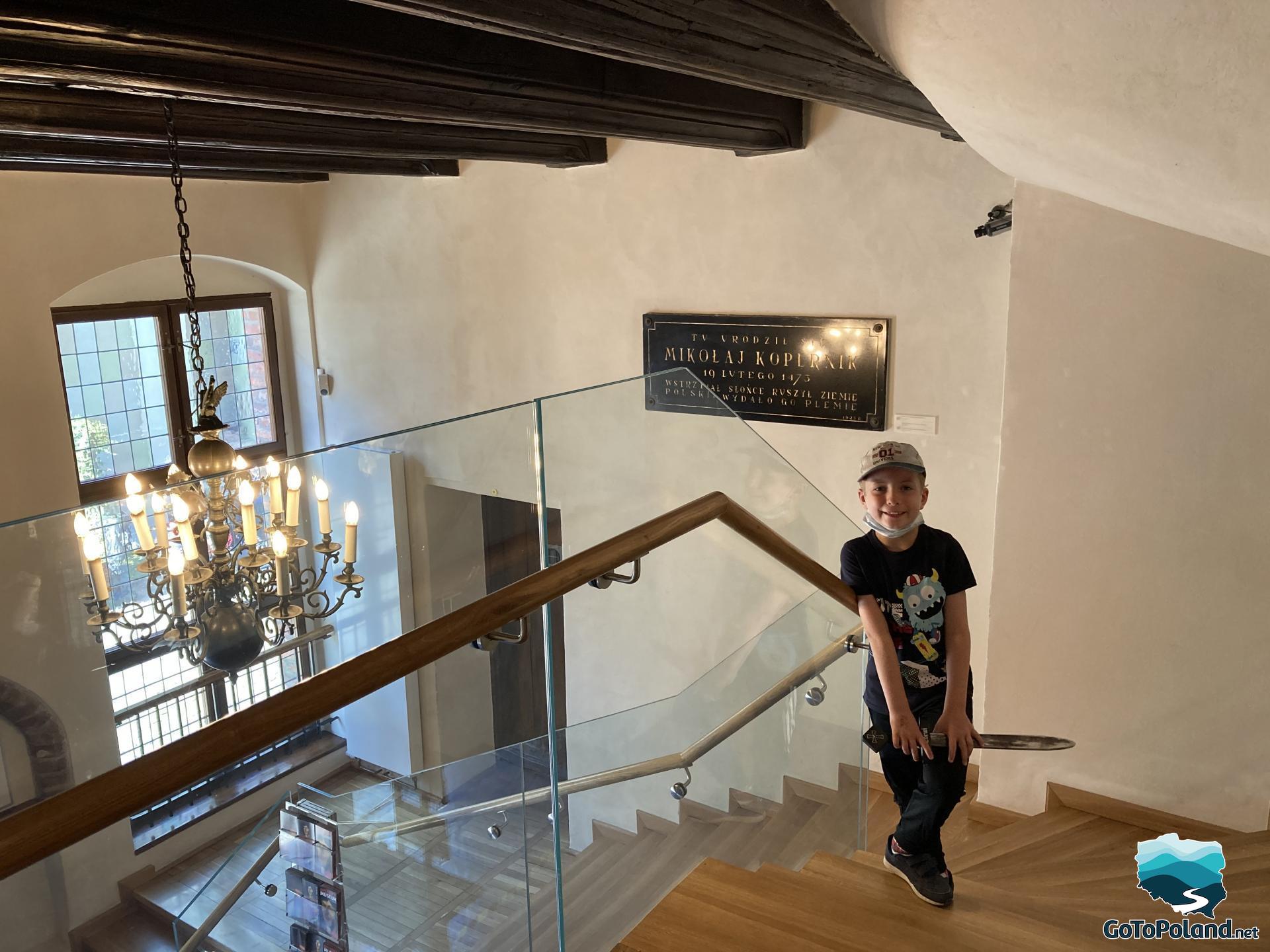 the boy is climbing the stairs to the first floor in the house where Copernicus lived