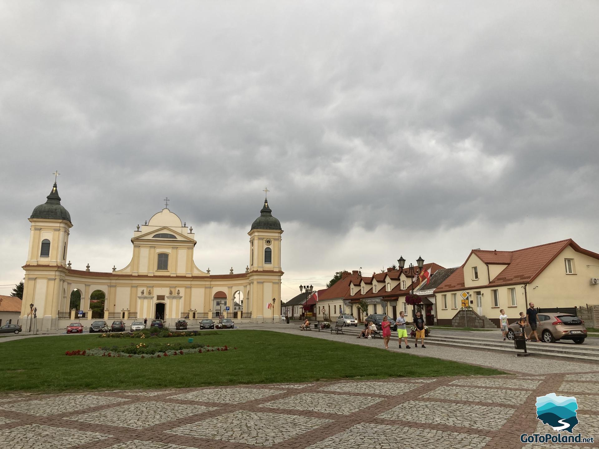 a main square with a yellow church