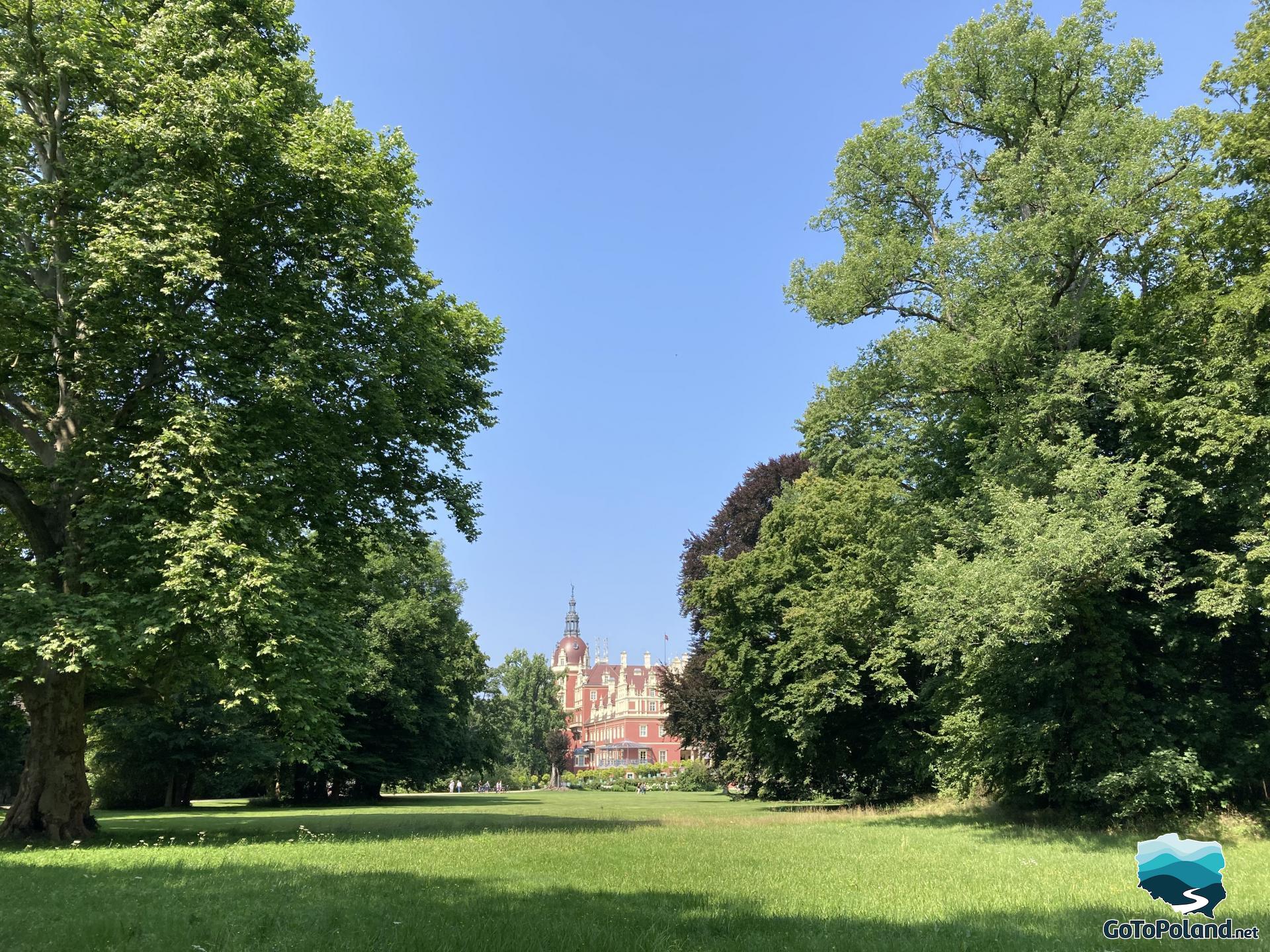 The Renaissance castle emerges from behind the trees