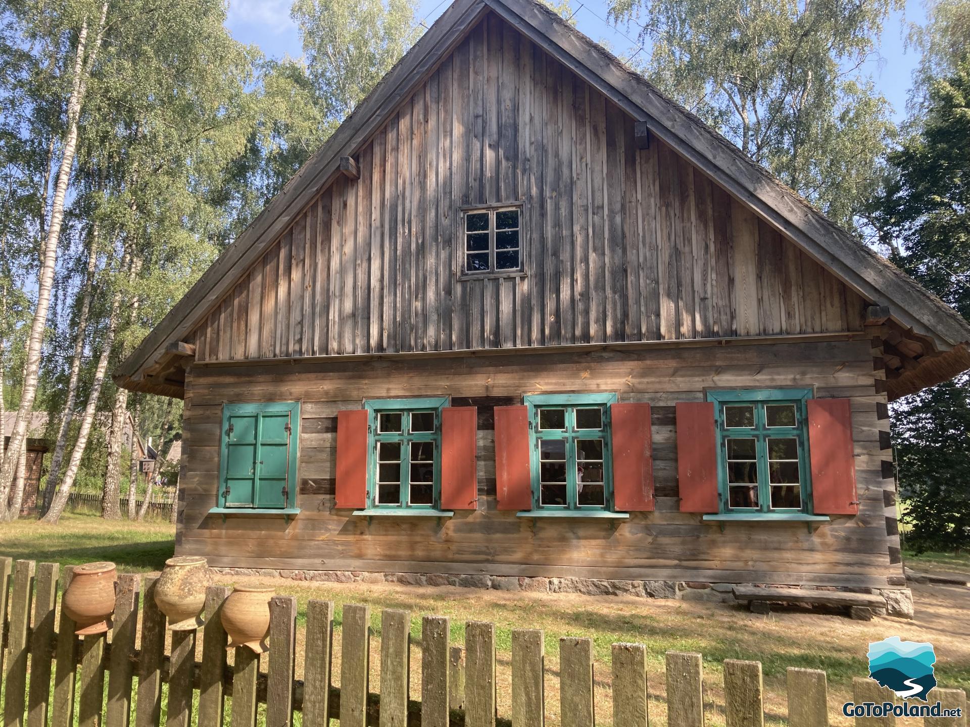 a peasant hut with colourful window frames