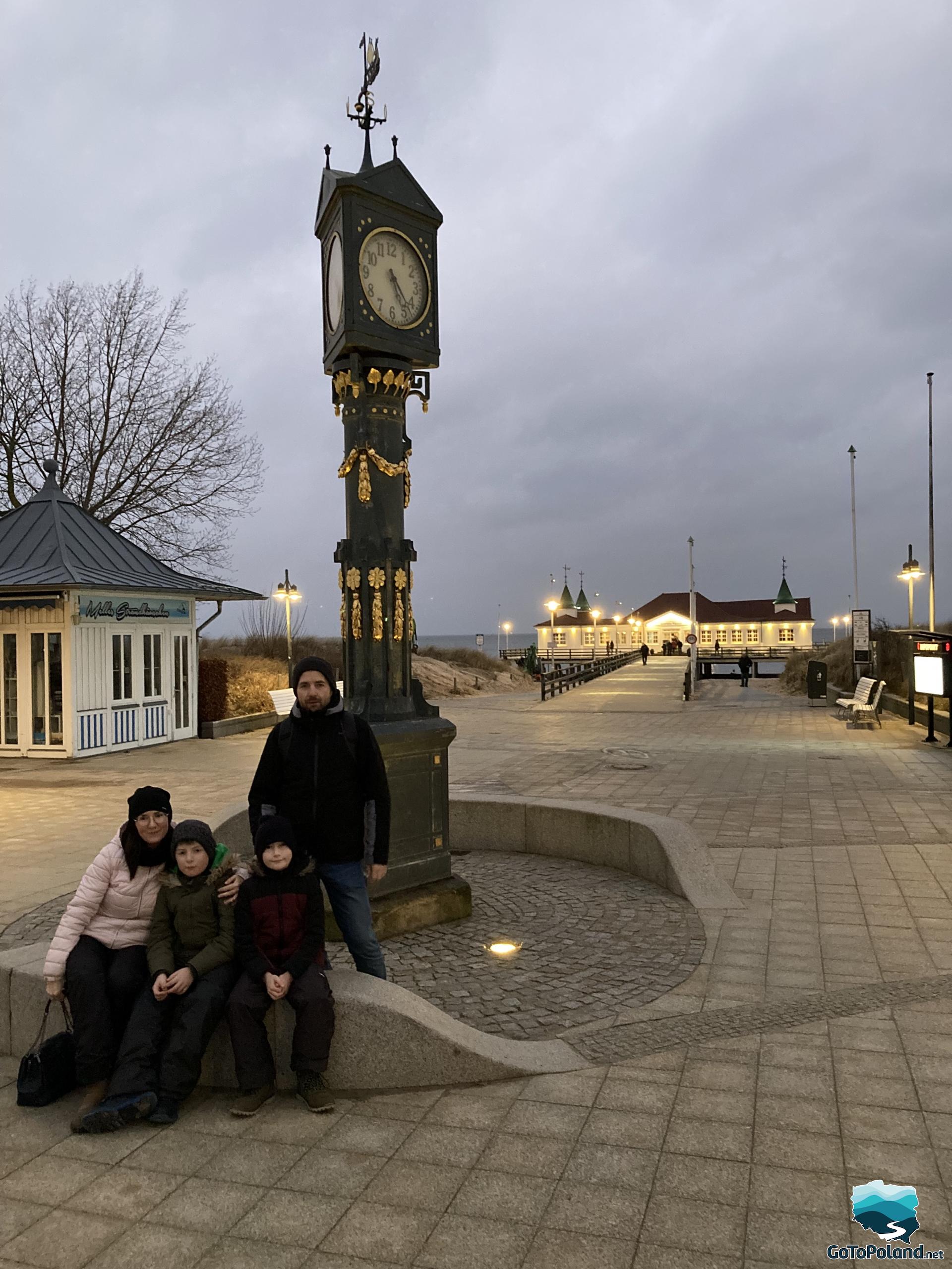 the family is at the historic outdoor clock