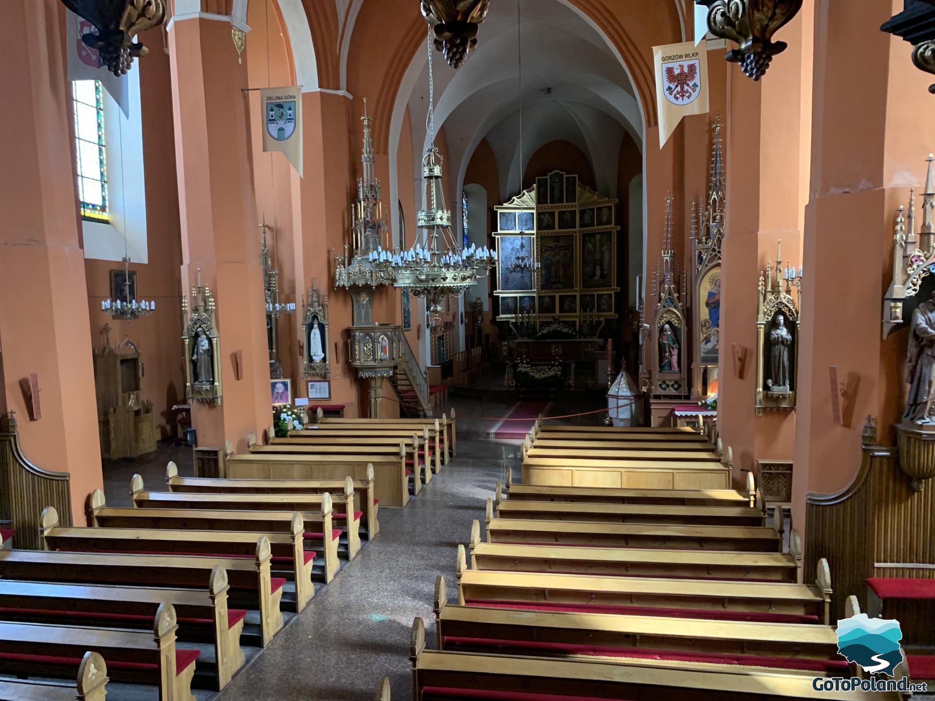 rows of pews in the church, the main altar in the background