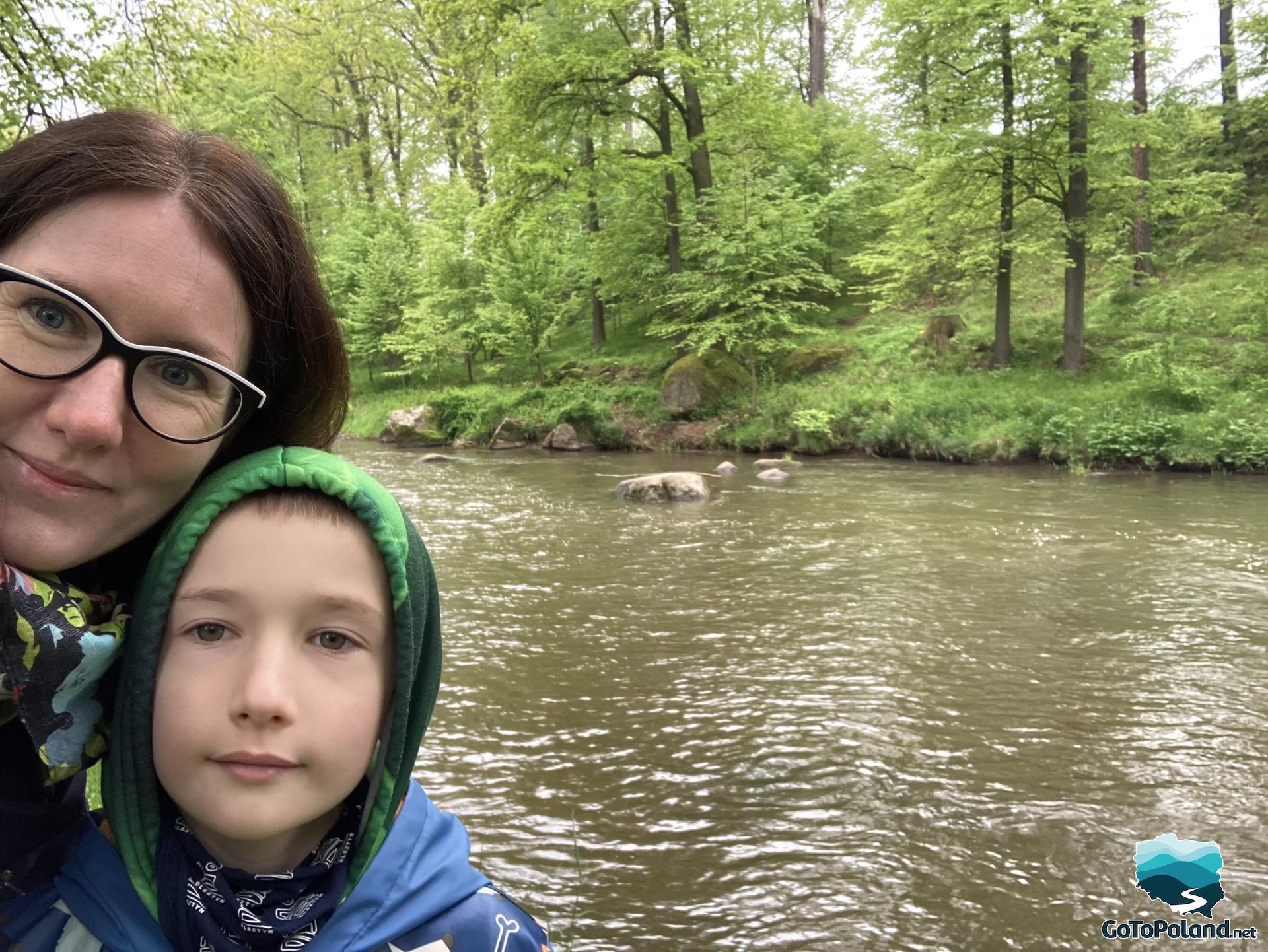 A woman and a boy by the river  