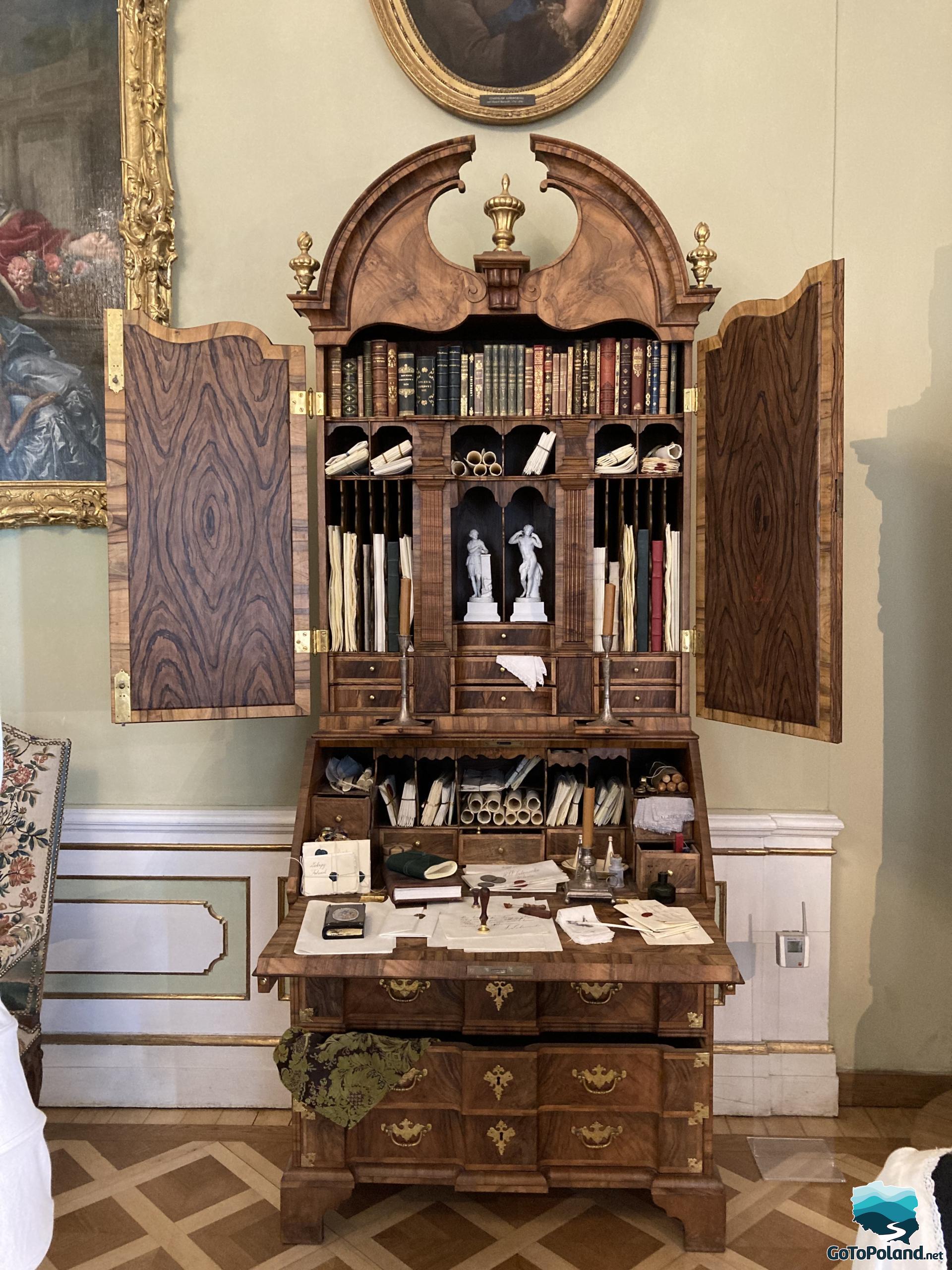 a decorative bookcase with many drawers, books and piece of papers