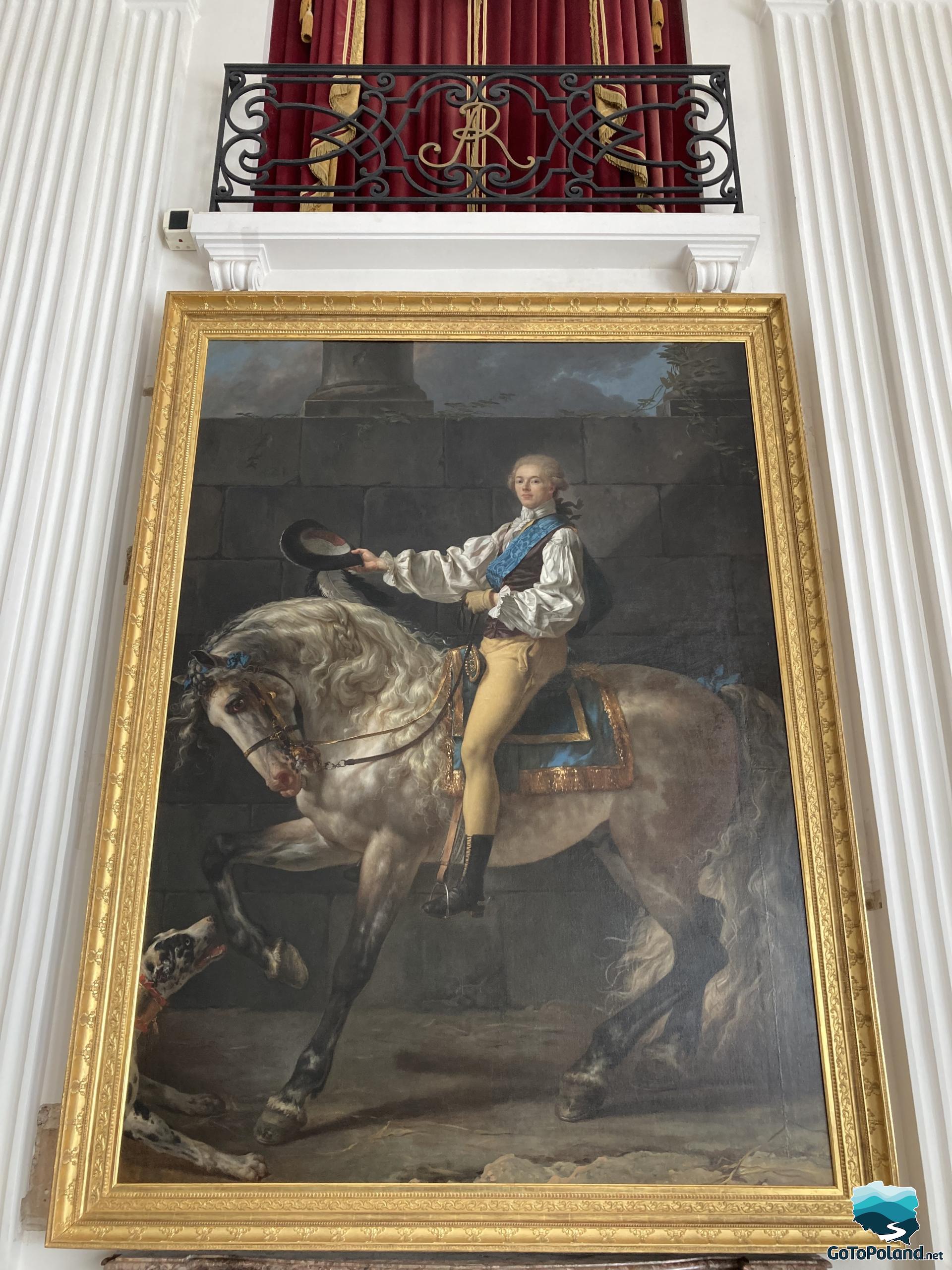 a large painting of a rider on a horse in a golden frame