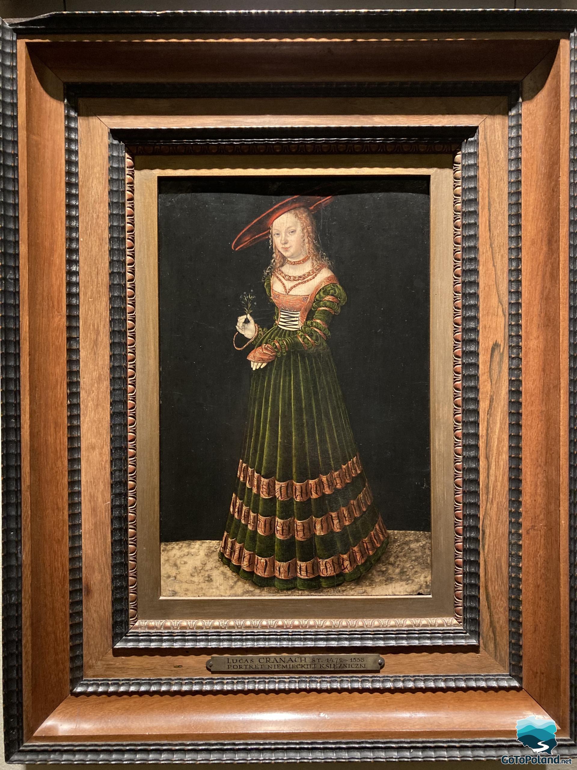 a Cranachs painting shows a girl in a green long dress with few orange stripes on a dress and with a red hat